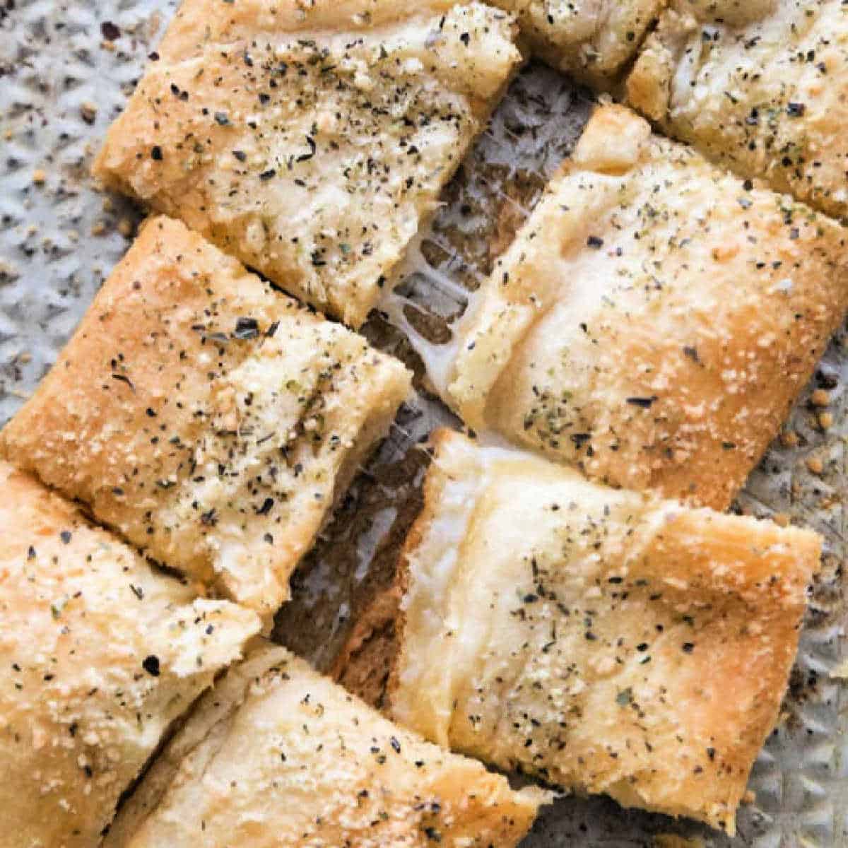 Cheesy bread on a baking sheet