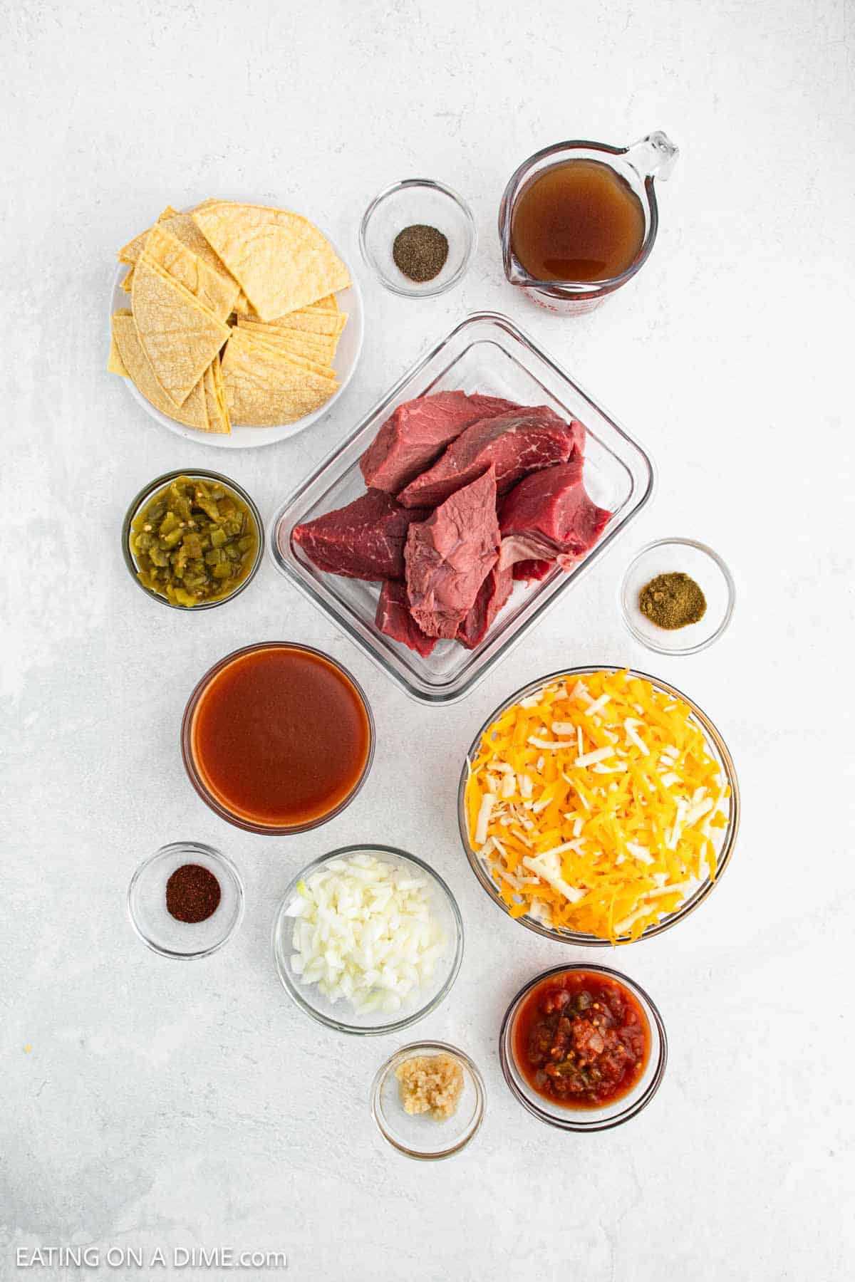 Ingredients - Rump Roast, red enchilada sauce, salsa, green chilies, garlic, onion, chili powder, cumin, pepper, beef broth, corn tortillas, cheese