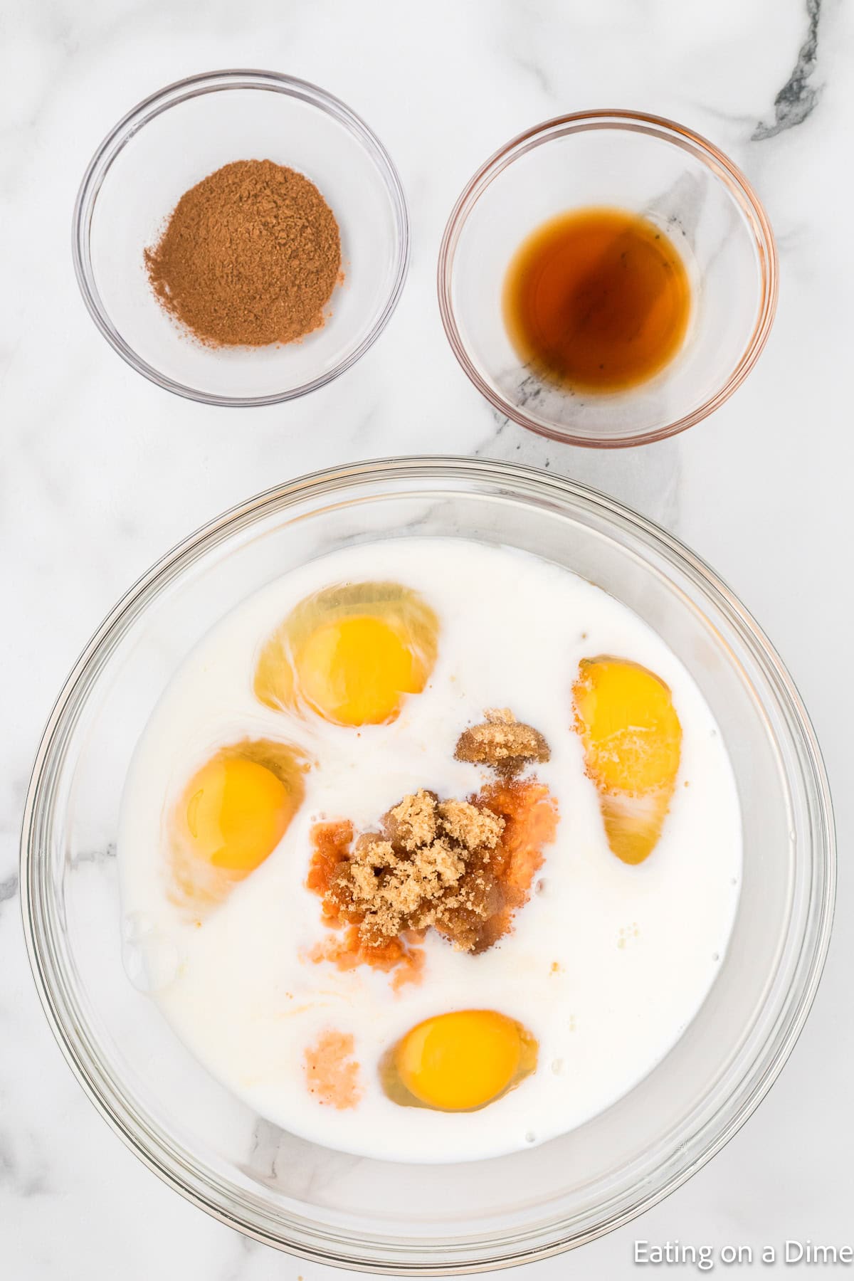 Combining the eggs, milk, pumpkin and brown sugar in a bowl