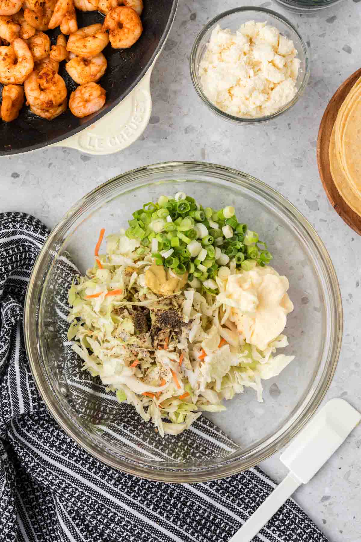 Combining the slaw ingredients in a bowl 