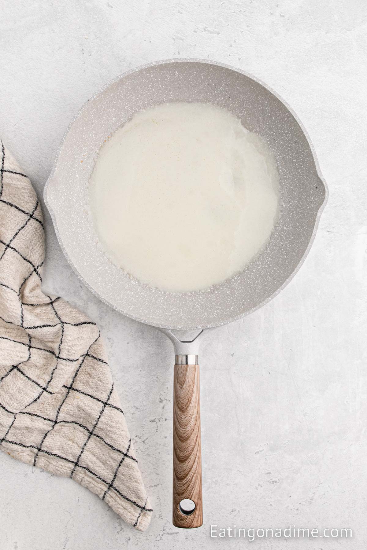 Crepe batter spread in a skillet