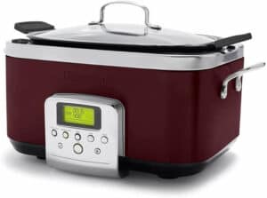 The best multicookers feature designs like this red and silver rectangular slow cooker with a digital display and control buttons on the front. It boasts a clear glass lid with a metal handle, and the brand name "GreenPan" is embossed prominently for an elegant finishing touch.