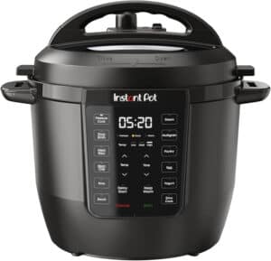 A black Instant Pot Duo pressure cooker, hailed as one of the best multicookers, features a digital control panel with various cooking functions and a timer set to 5:20. The lid has a handle and clear "Close" and "Open" markings for ease of use.