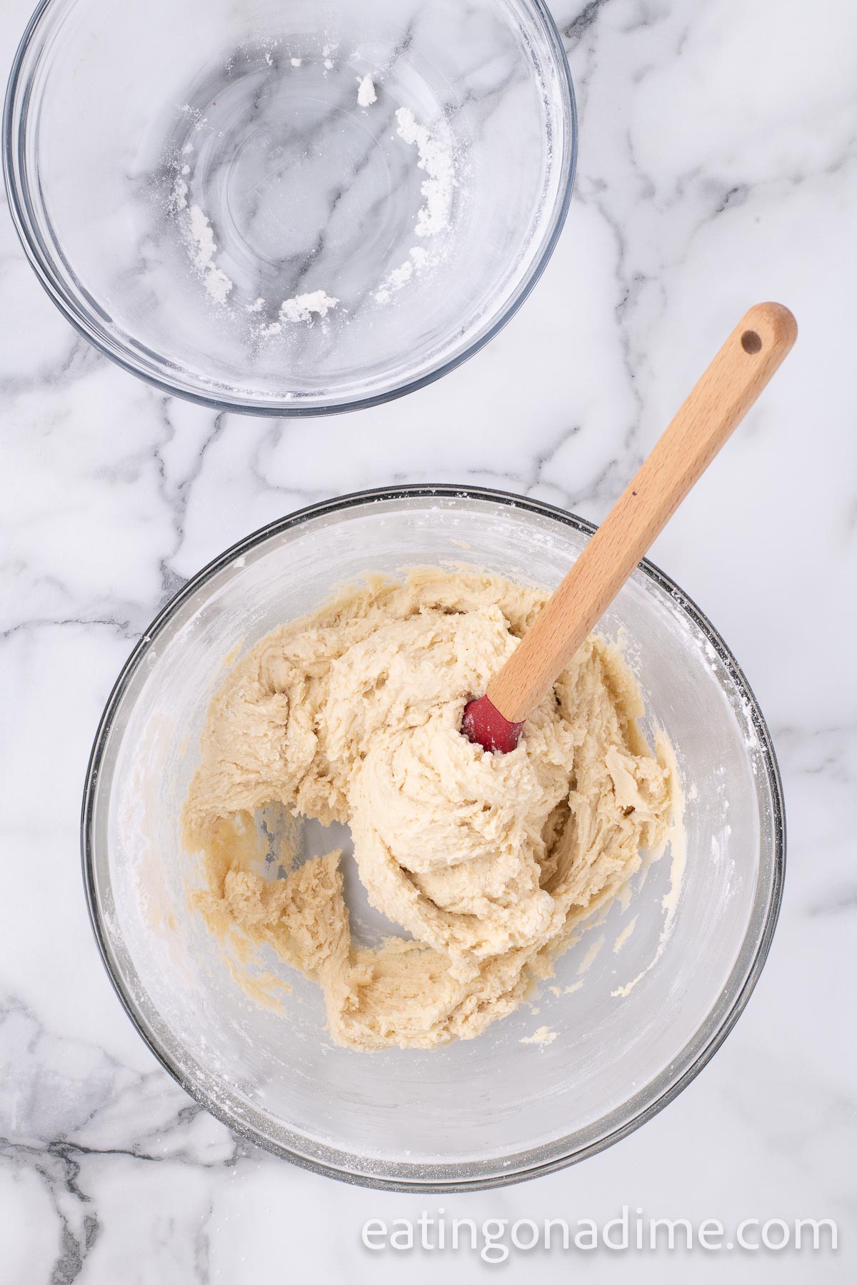 Combining the dry and wet ingredients in a bowl with a spatula