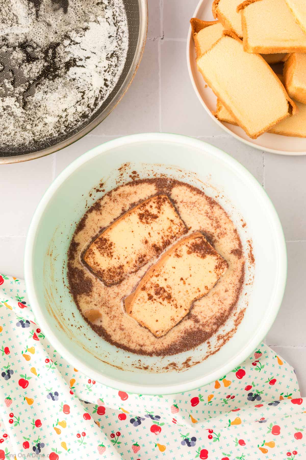 Dipping the pound cake slices in a bowl with the cinnamon mixture 