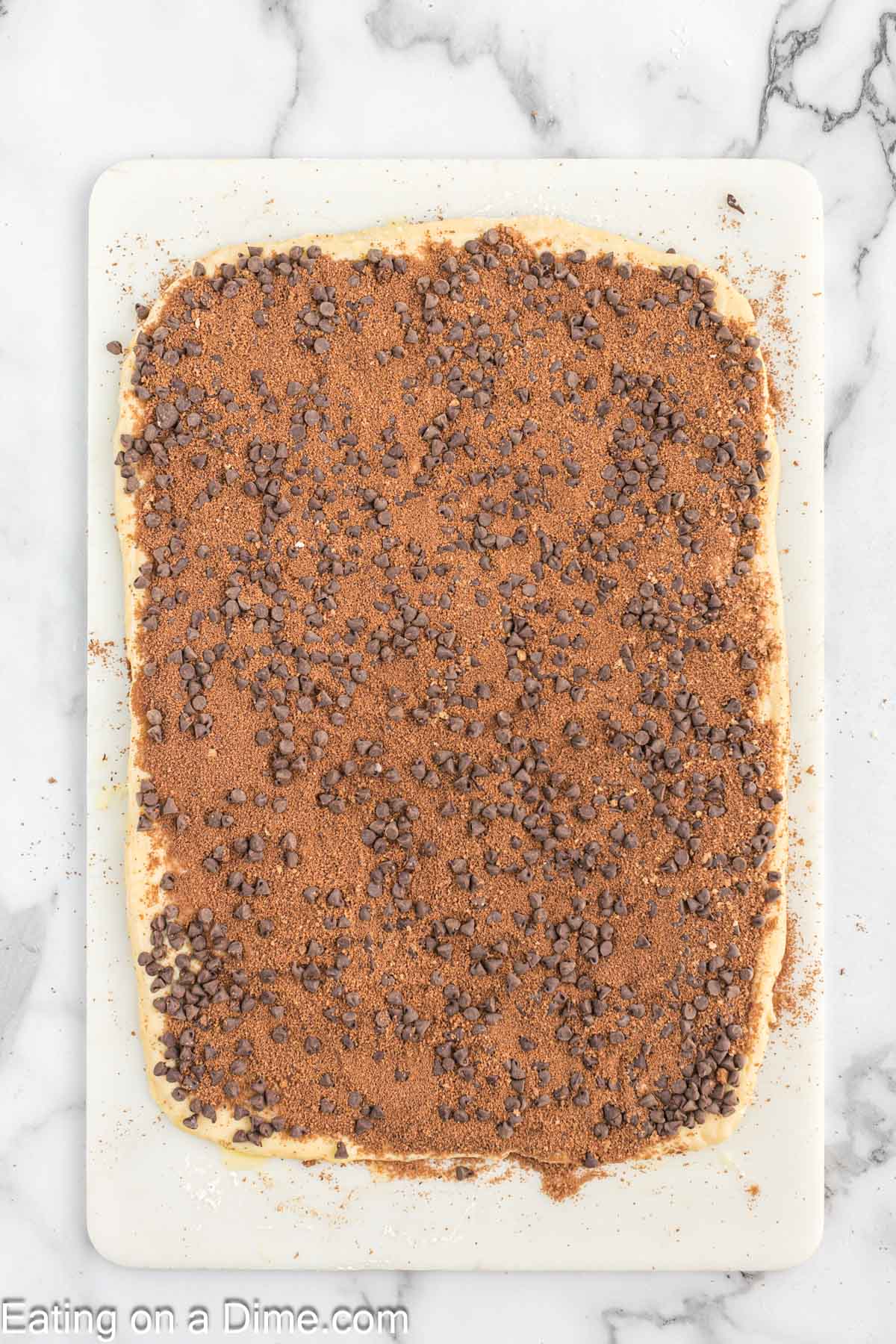 Chocolate mixture spread on the dough topped with chocolate chips