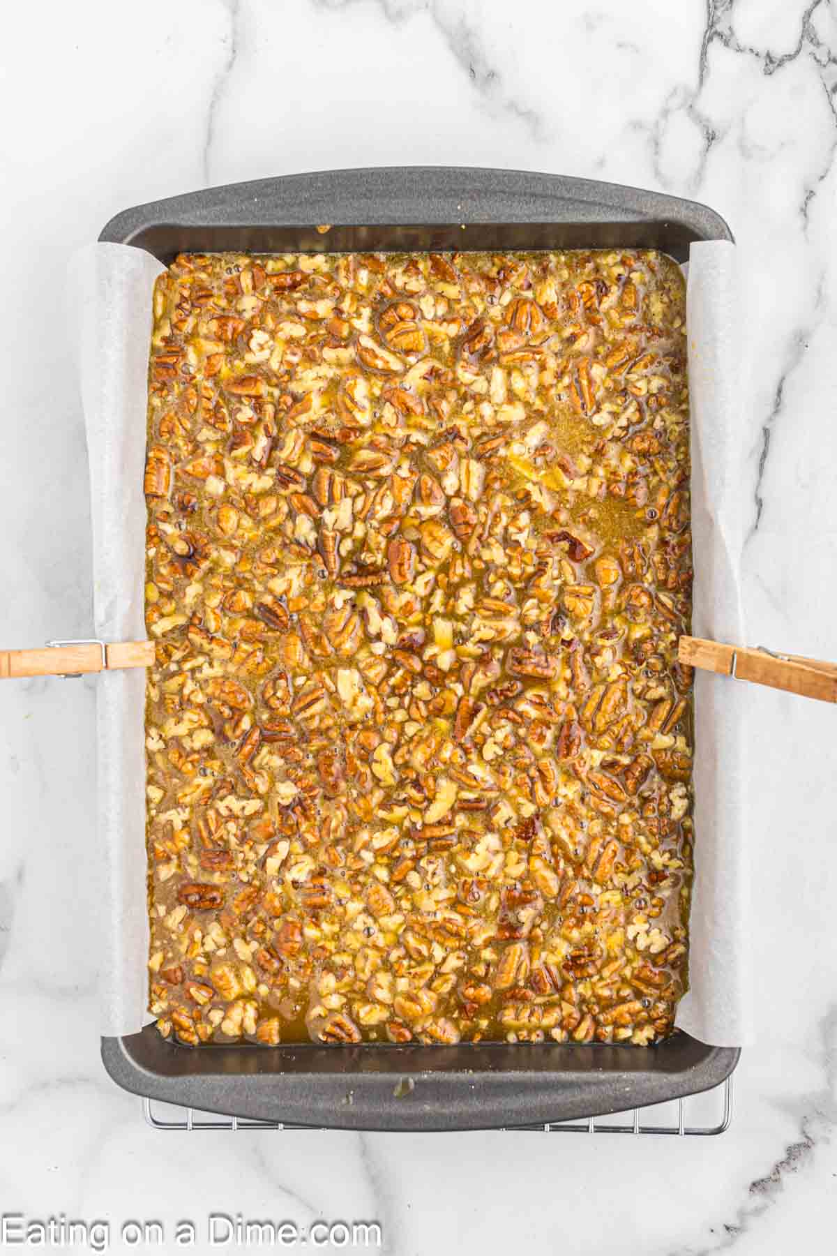 Pecan pie filling poured into the baking dish 