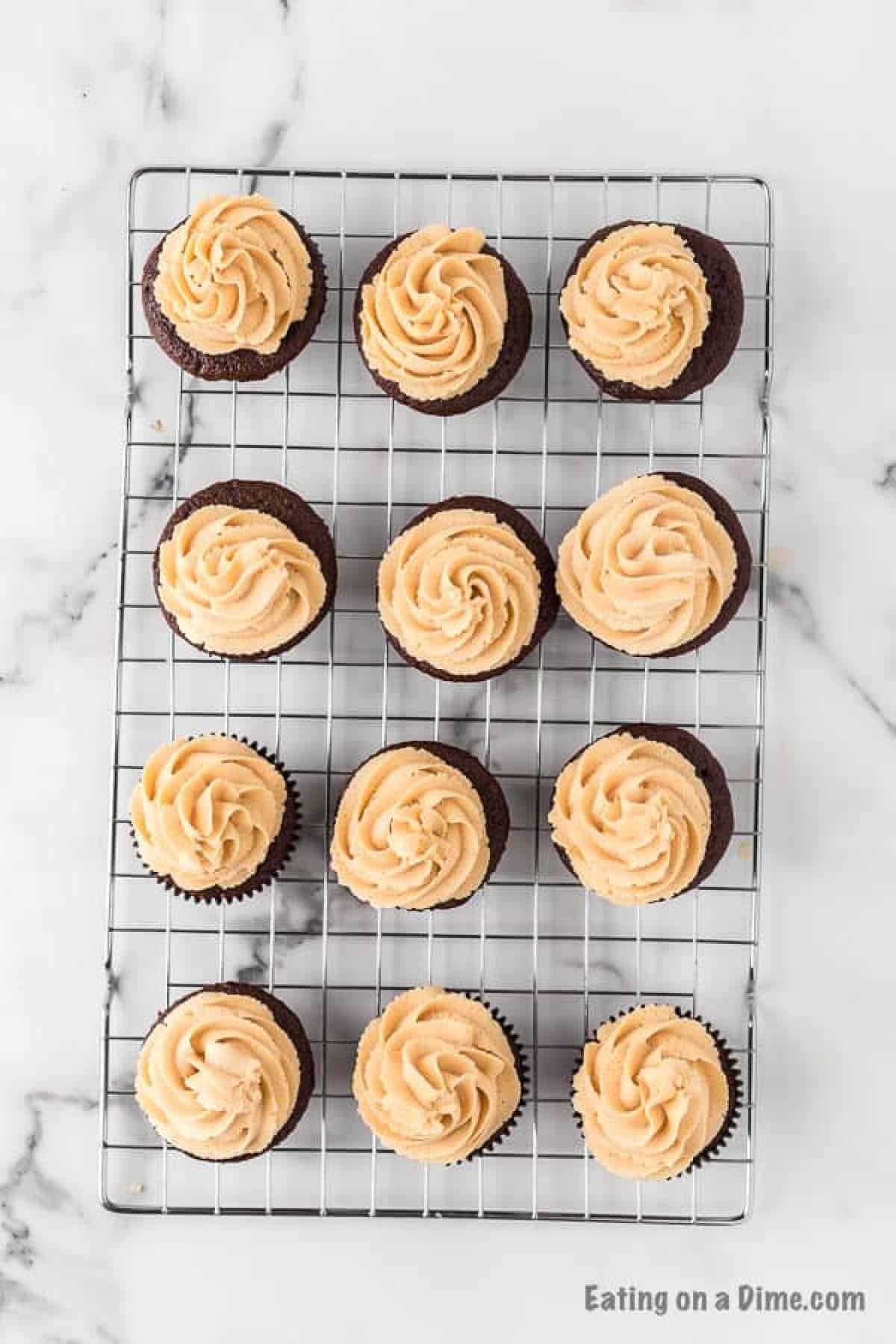 Topping the chocolate cupcakes with the peanut butter frosting