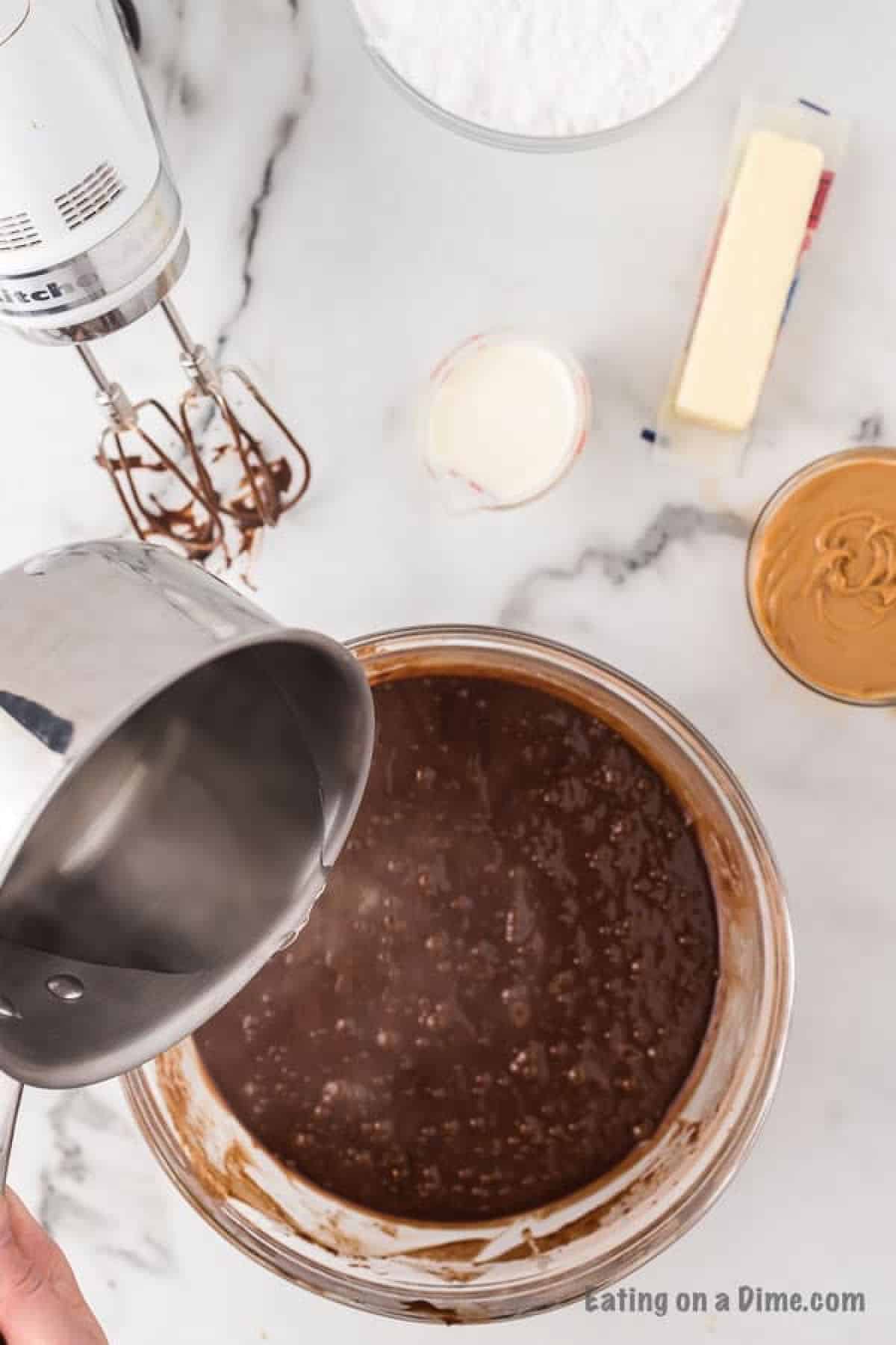 Pouring boiling water into the cupcake mixture