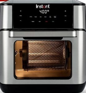 A stainless steel air fryer oven with a digital display showing 400°F. Widely regarded as one of the best stainless steel air fryers, its transparent door reveals a rotating mesh basket inside.