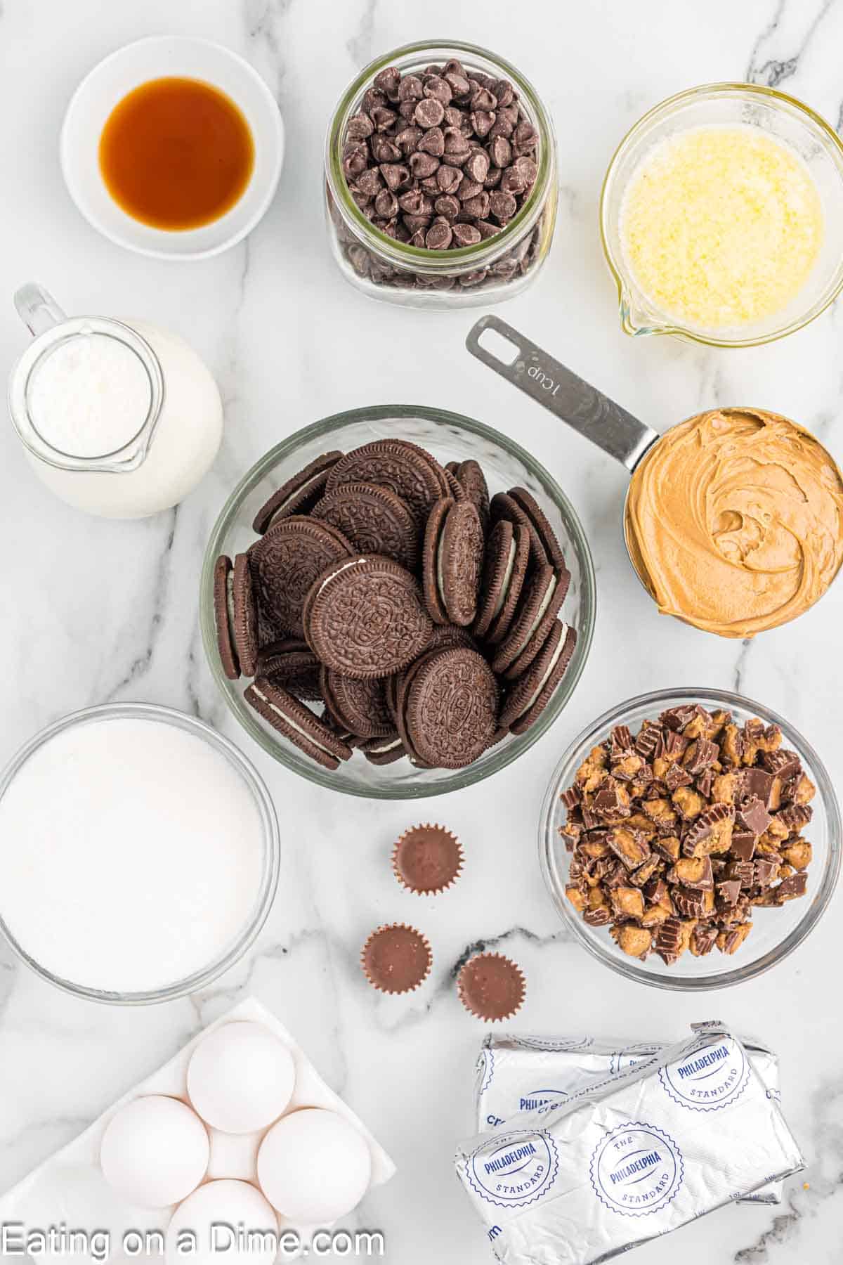 Ingredients - Oreo Cookies, Butter, Cream Cheese, sugar, vanilla extract, peanut butter, eggs, heavy cream, peanut butter cups, chocolate chips