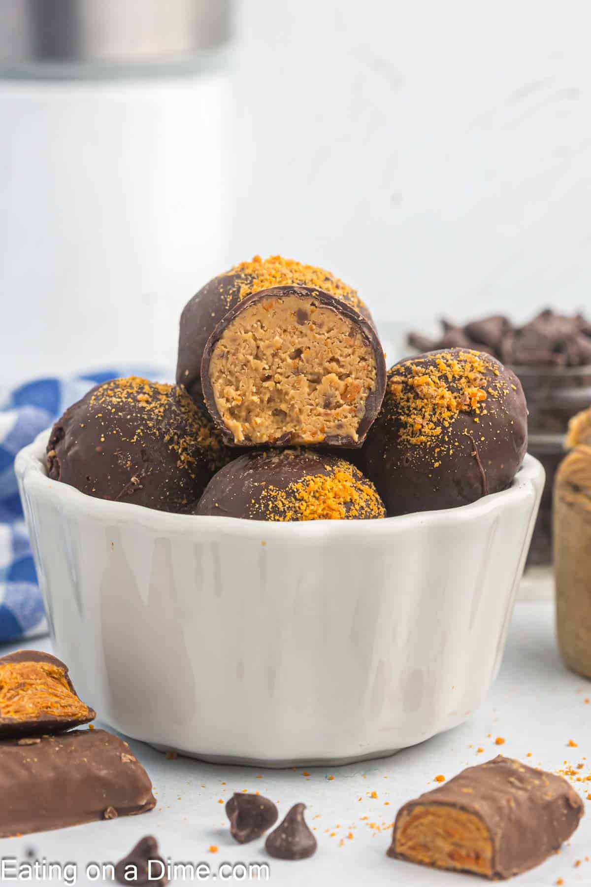 Butterfinger balls stacked in a white bowl