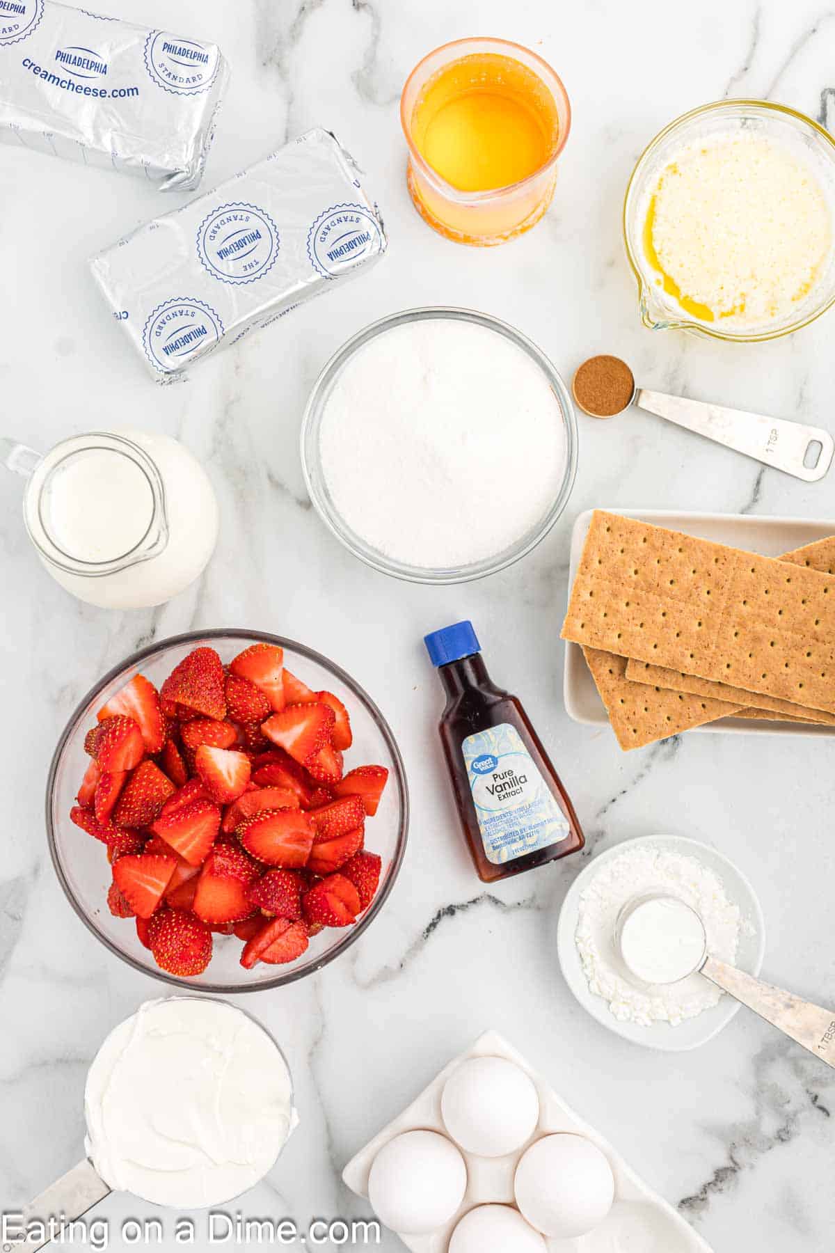 Ingredients - Graham cracker crumbs, melted butter, sugar, cinnamon, strawberries, cornstarch, cream cheese, vanilla extract, sour cream, eggs, heavy cream