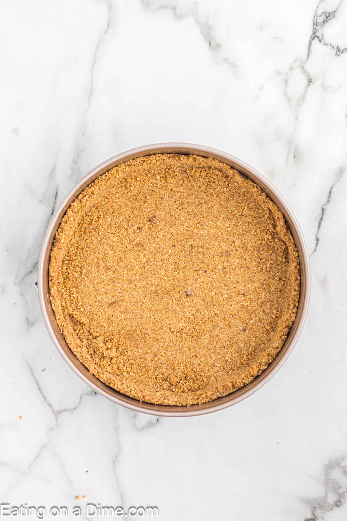 Pressing the crust ingredients in the springform pan