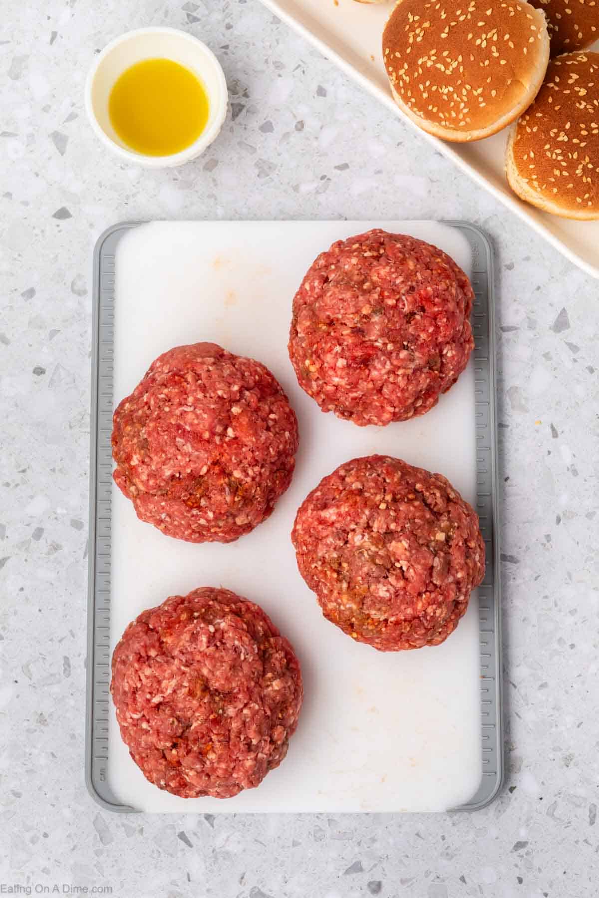 Large ground beef balls on a cutting board