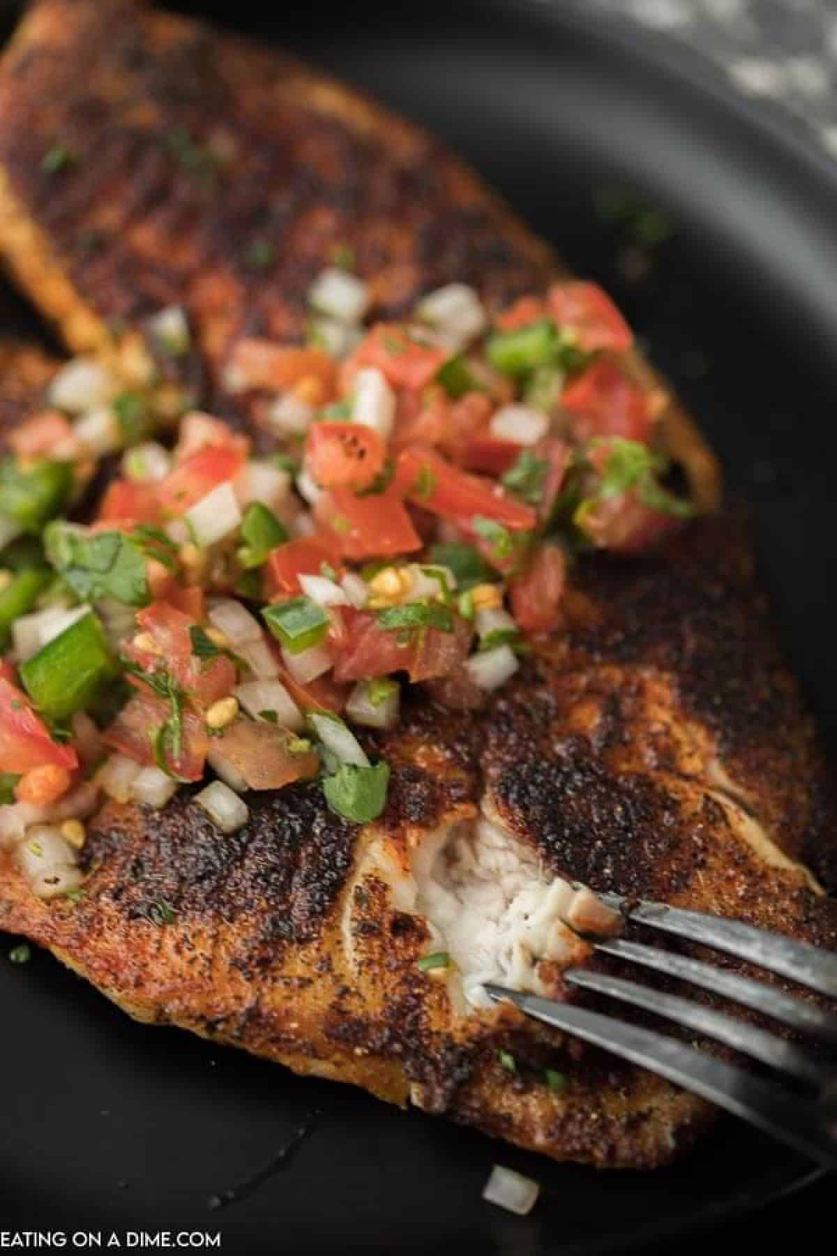 Blackened Tilapia topped with pico on a plate