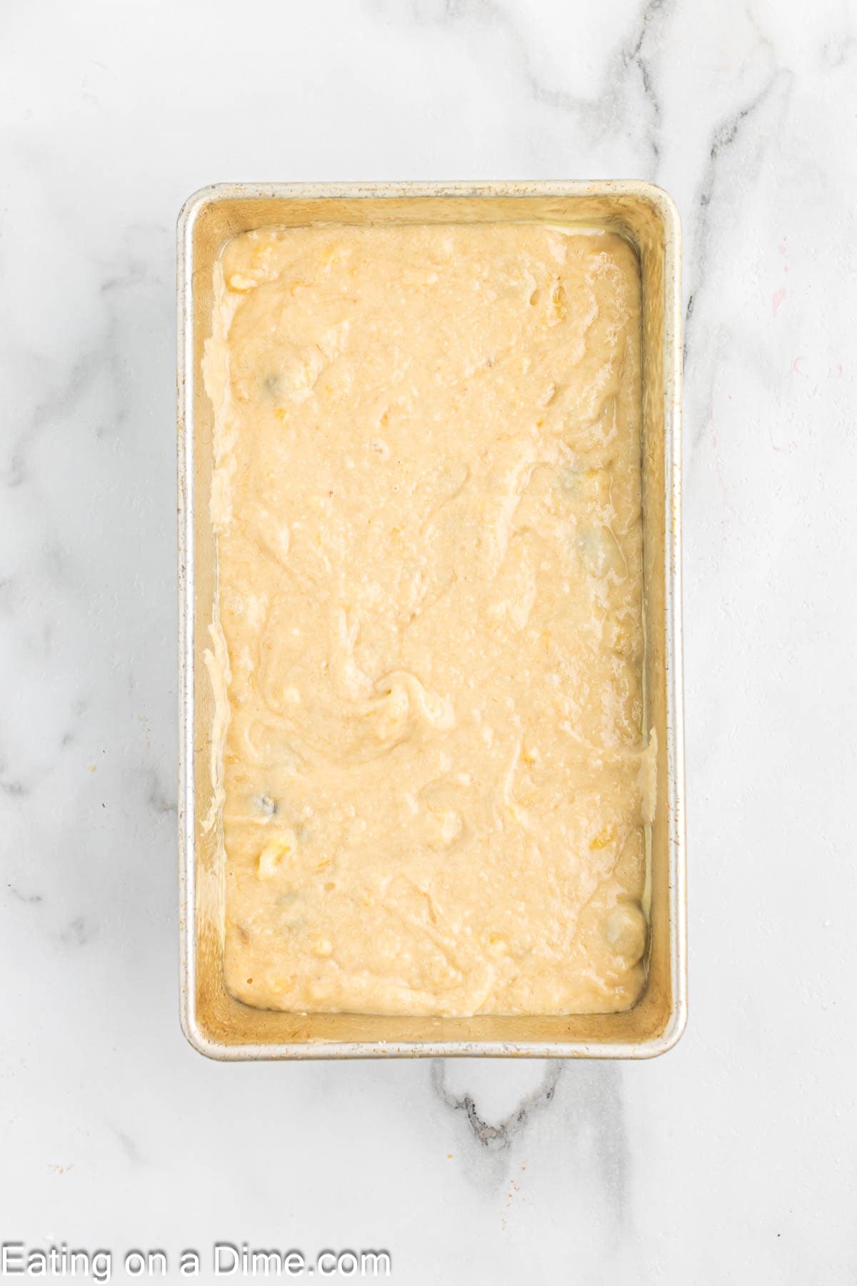 Blueberry banana bread batter in a loaf pan