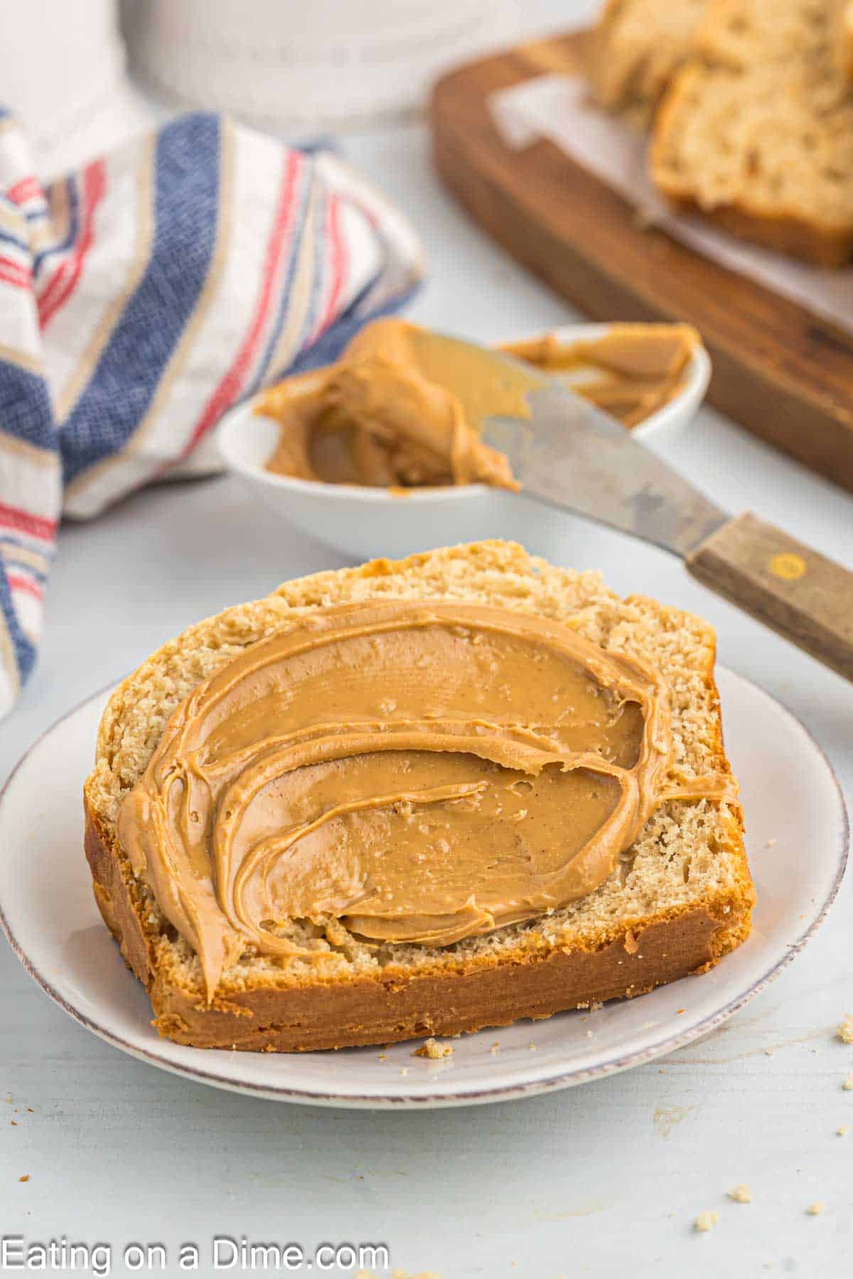 Peanut butter spread on a slice of bread on a plate