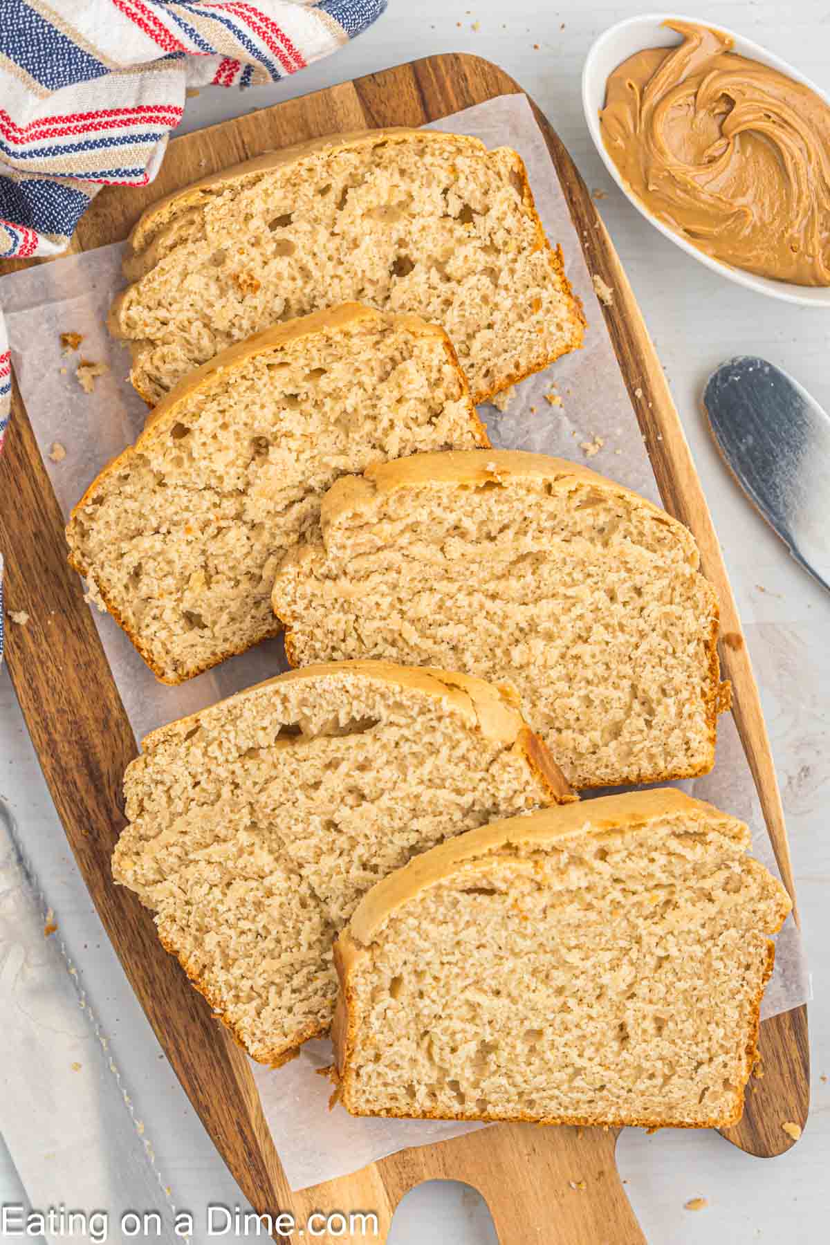 Peanut Butter Bread slices on a cutting board lined with parchment paper