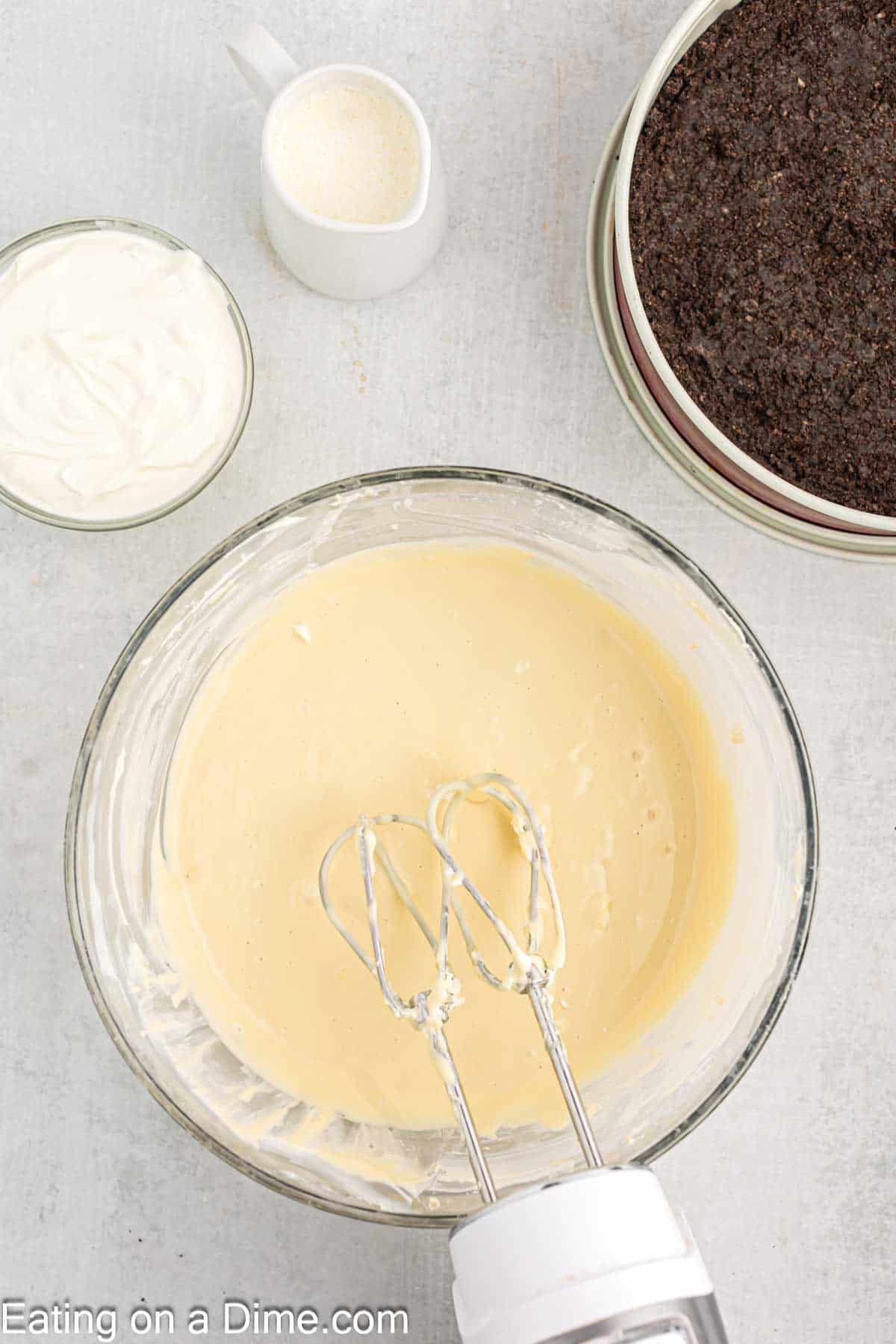 Mix in eggs into the cream cheese in a bowl with a hand mixer