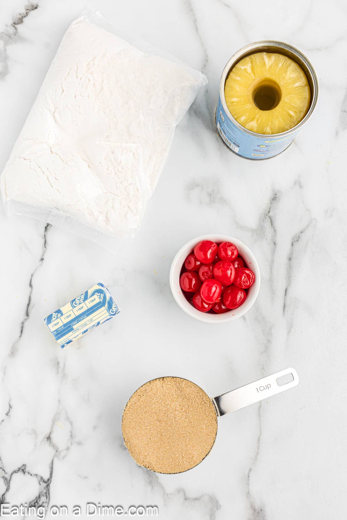 Ingredients - cake mix, bowl of cherries, stick of butter, brown sugar, and pineapple slices