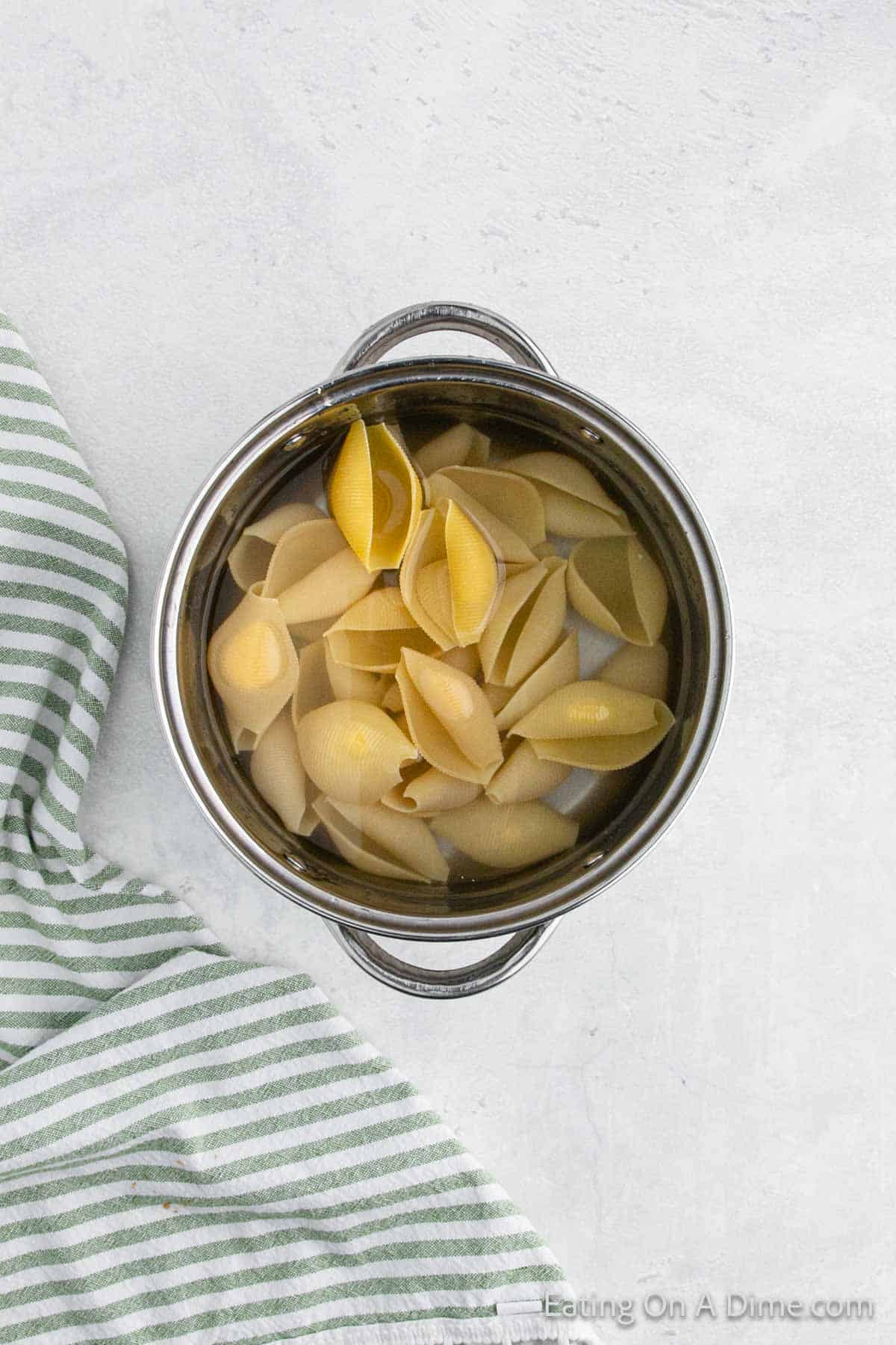 Pasta shells cooking in a large pot of water
