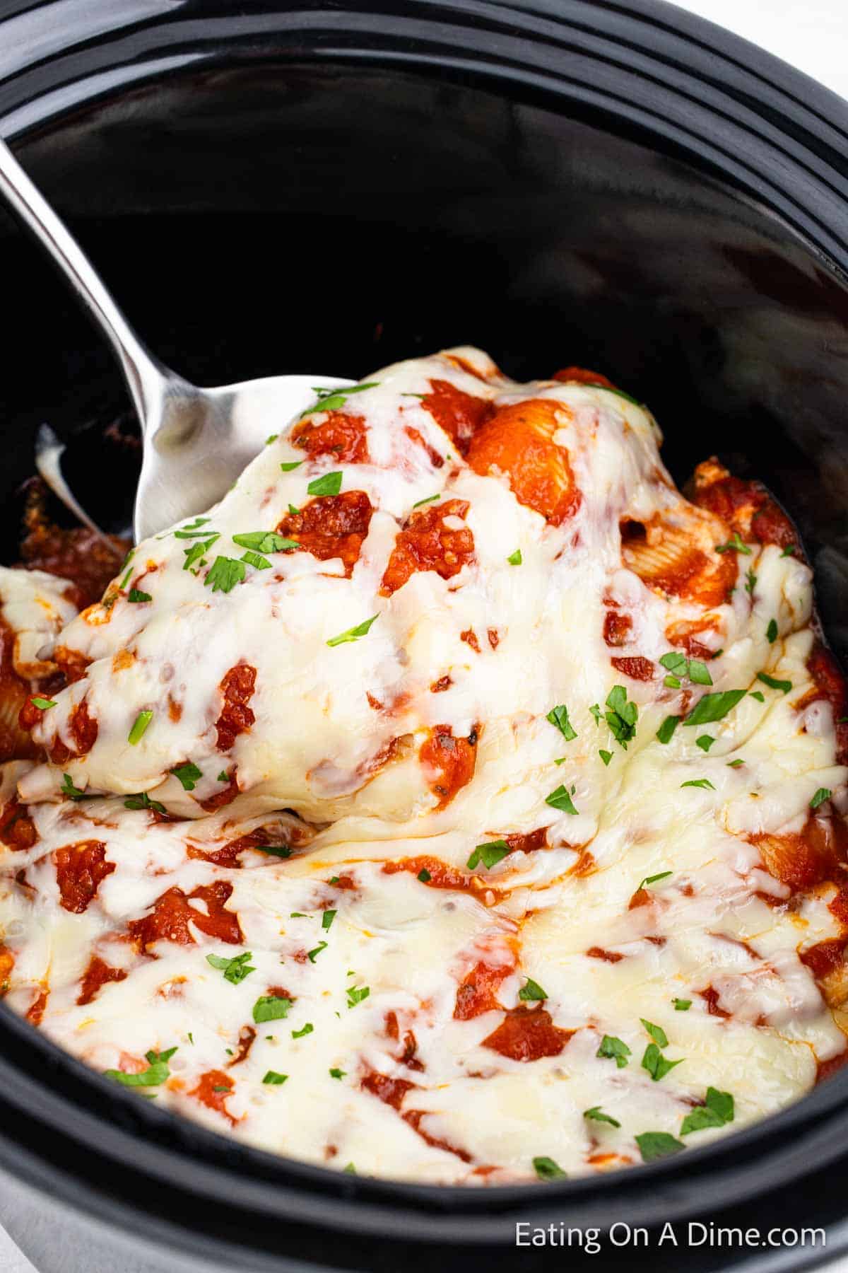 Stuffed shells in the slow cooker topped with melted chese