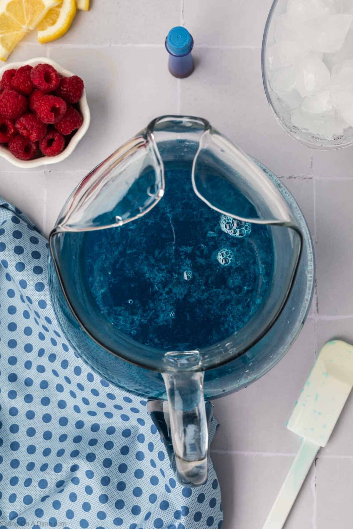 Blue lemonade in a glass pitcher