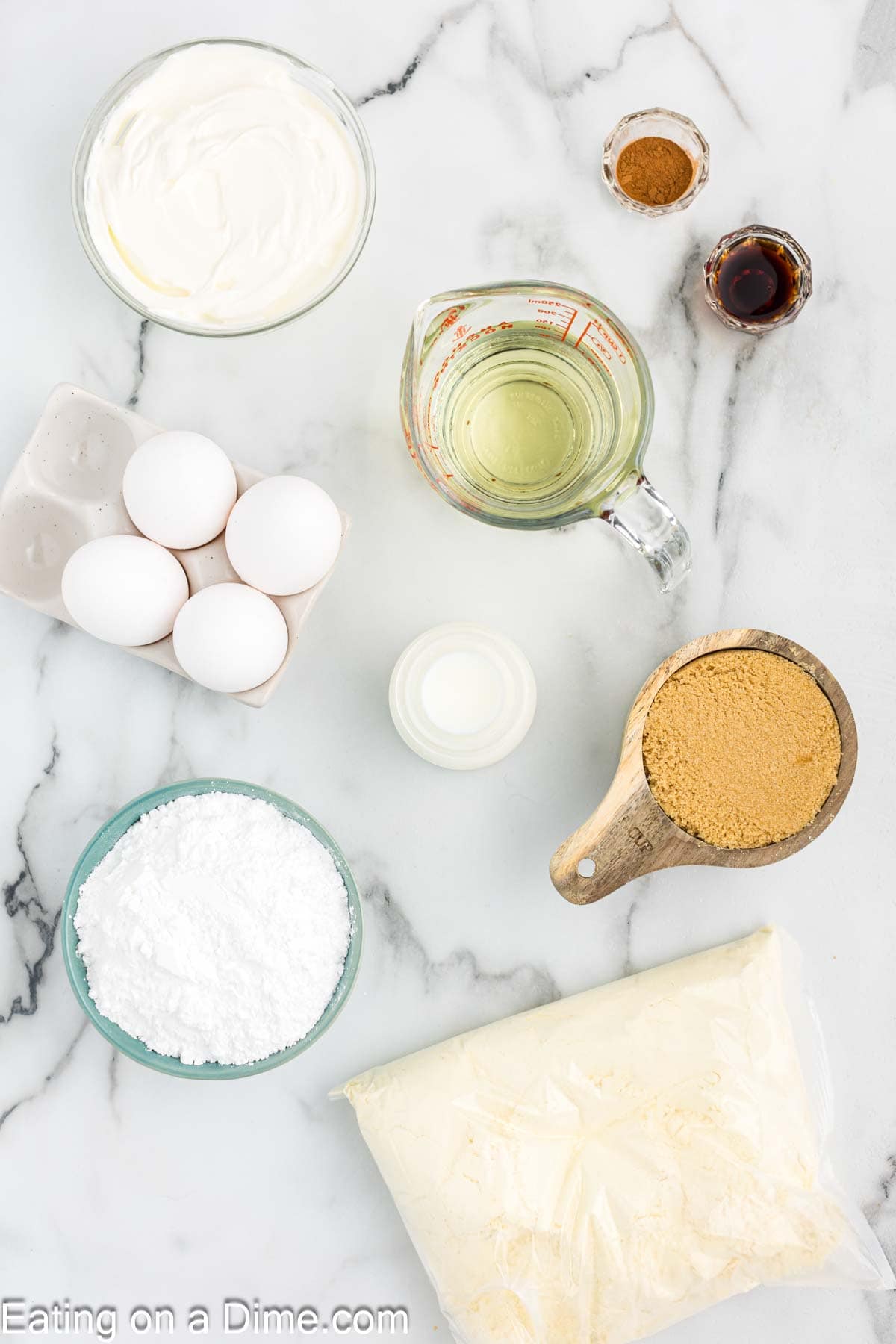 Honey Bun Cake Ingredients - Cake Mix, eggs, vanilla extract, sour cream, oil, brown sugar, cinnamon, powdered sugar, milk