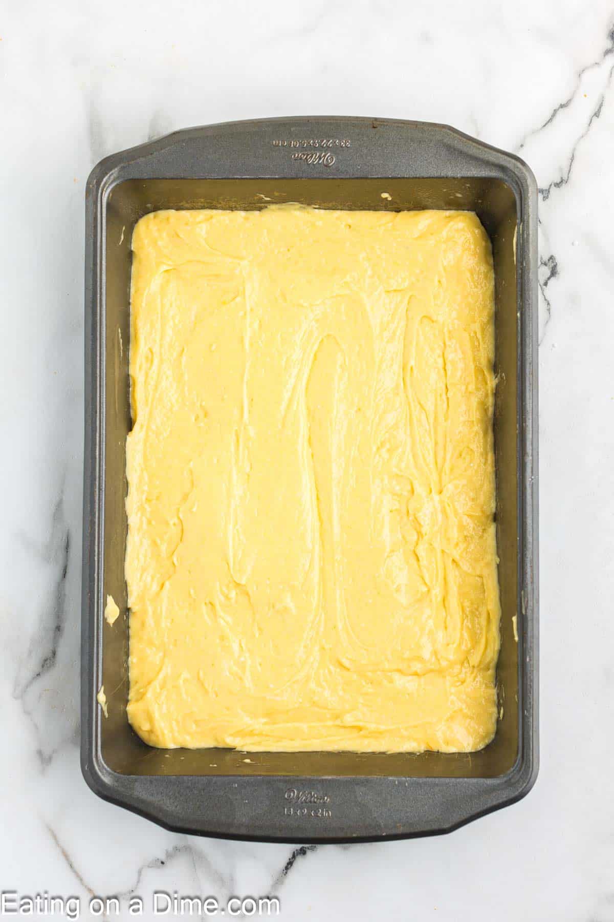 Cake batter spread in a baking dish
