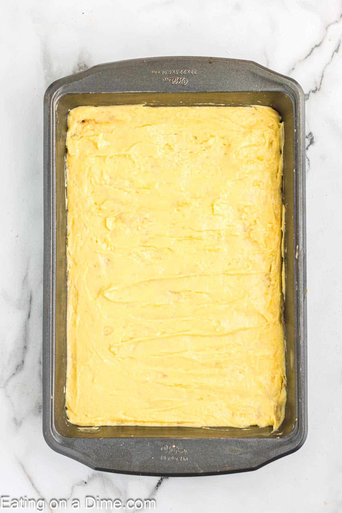 Cake batter spread in the baking dish