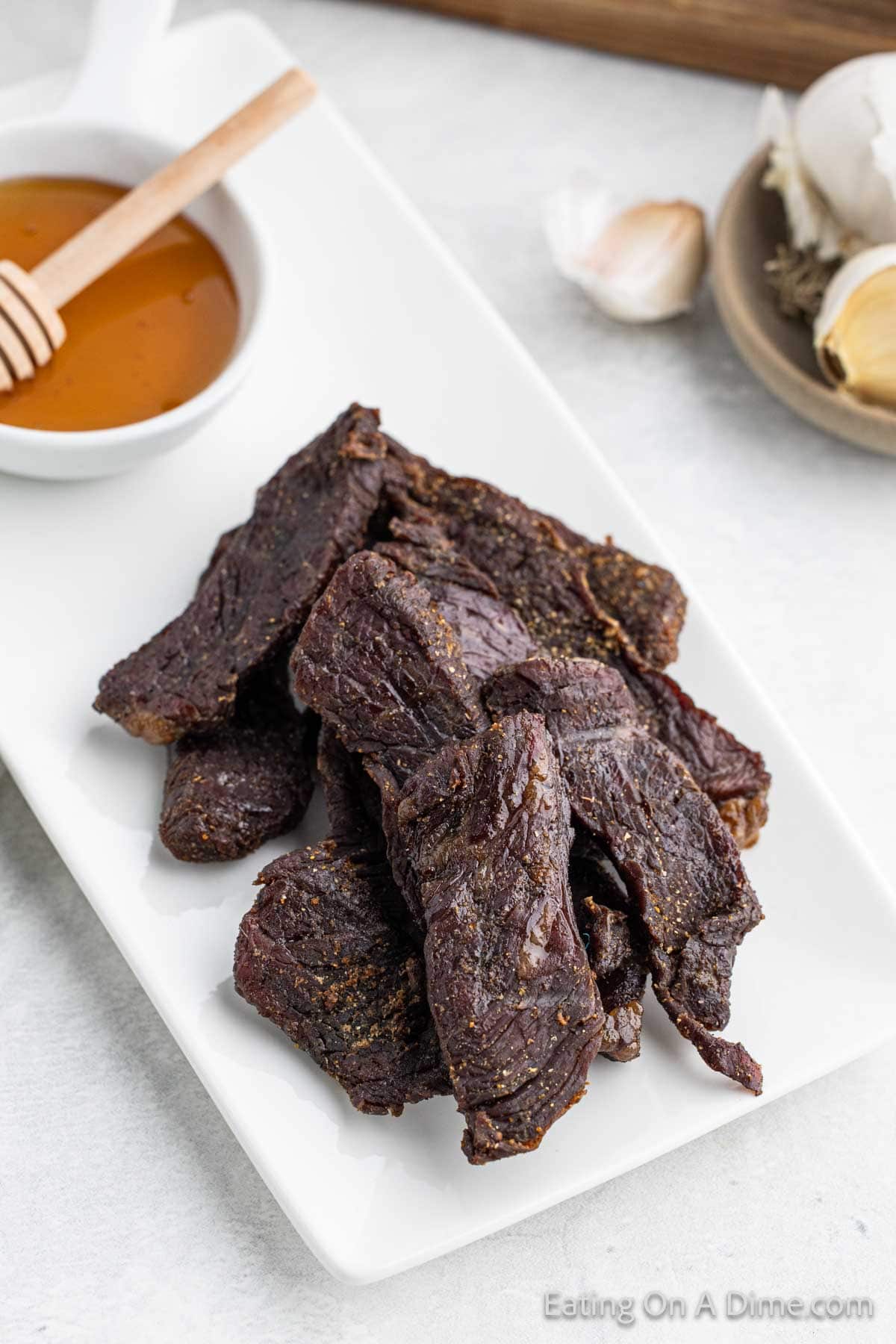 Beef jerky strips stacked on a plate