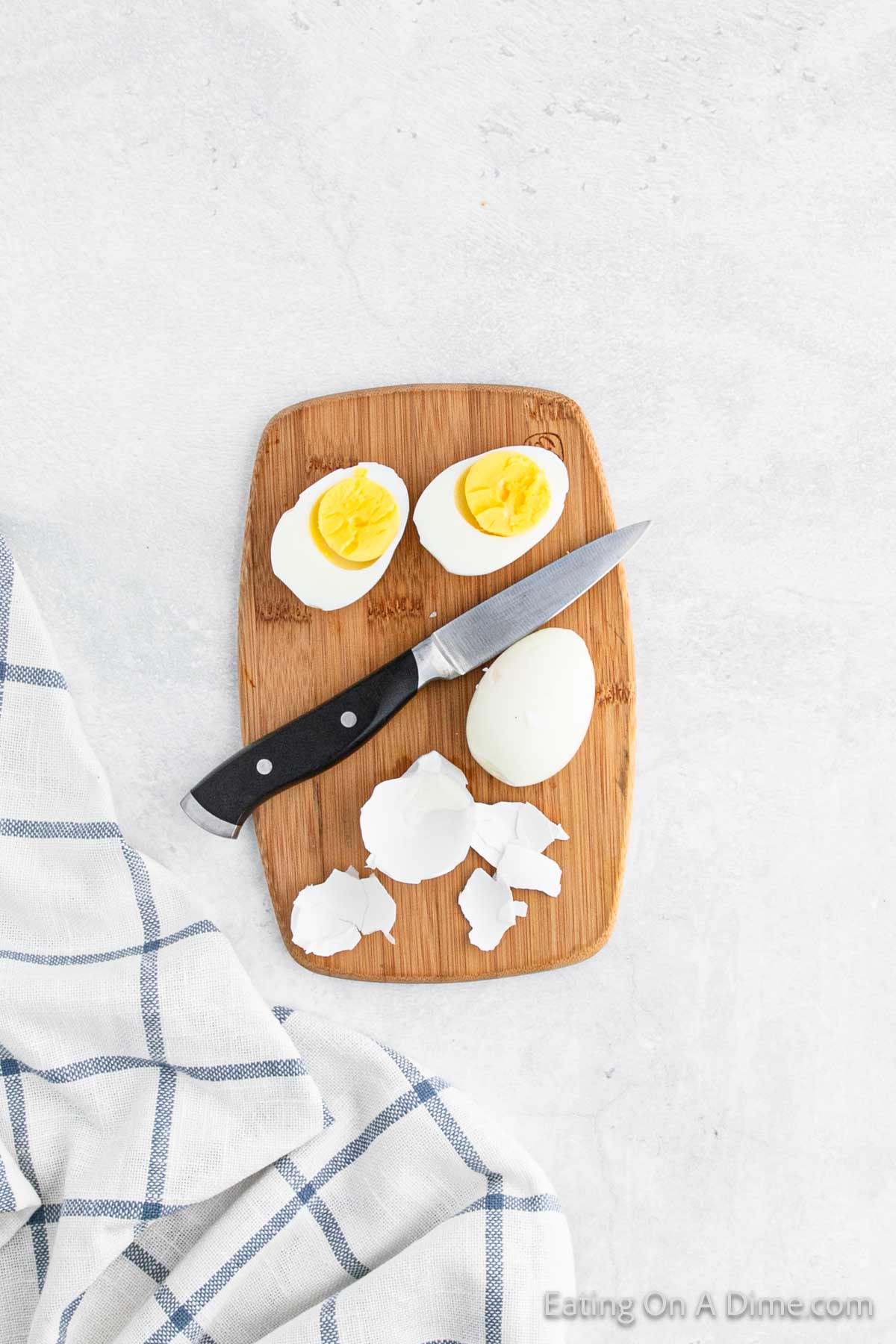 Slicing Hard Boiled Eggs on a Cutting Board with a knife