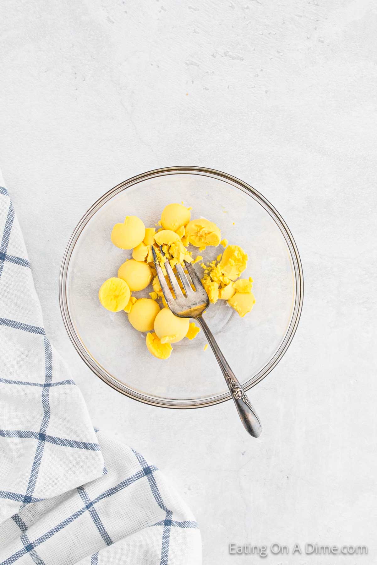 Egg yolks in a bowl with a fork