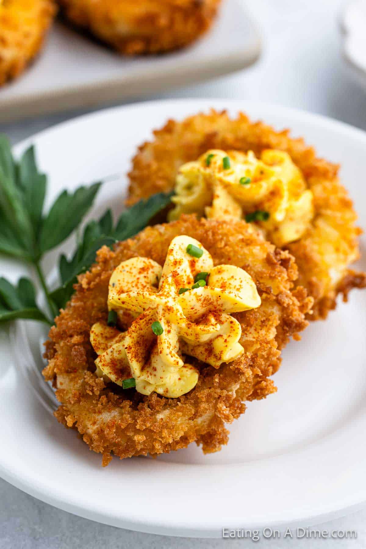 Fried Deviled Eggs stacked on a plate