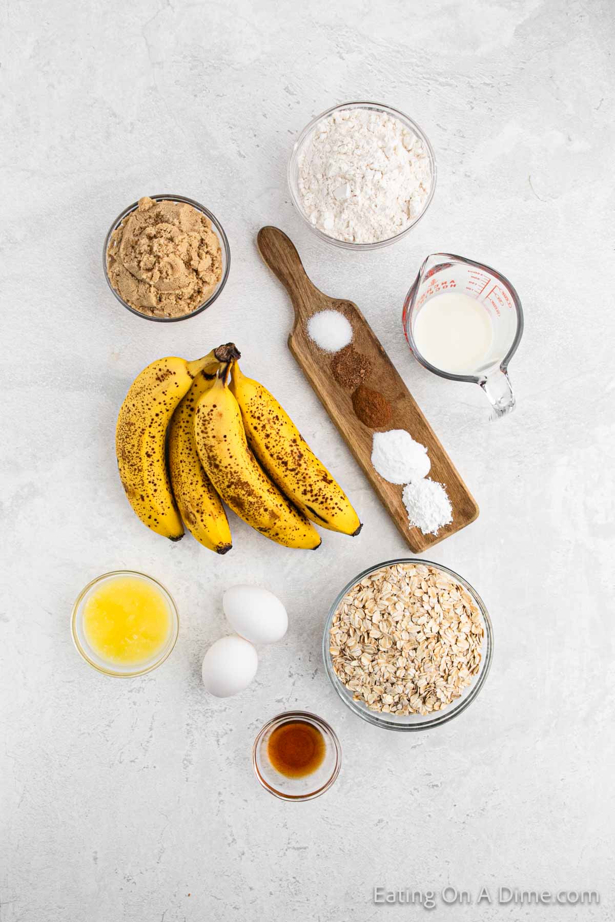 Oatmeal Banana Bread ingredients - brown sugar, flour, milk, seasoning, bananas, melted butter, vanilla, eggs, and oatmeal