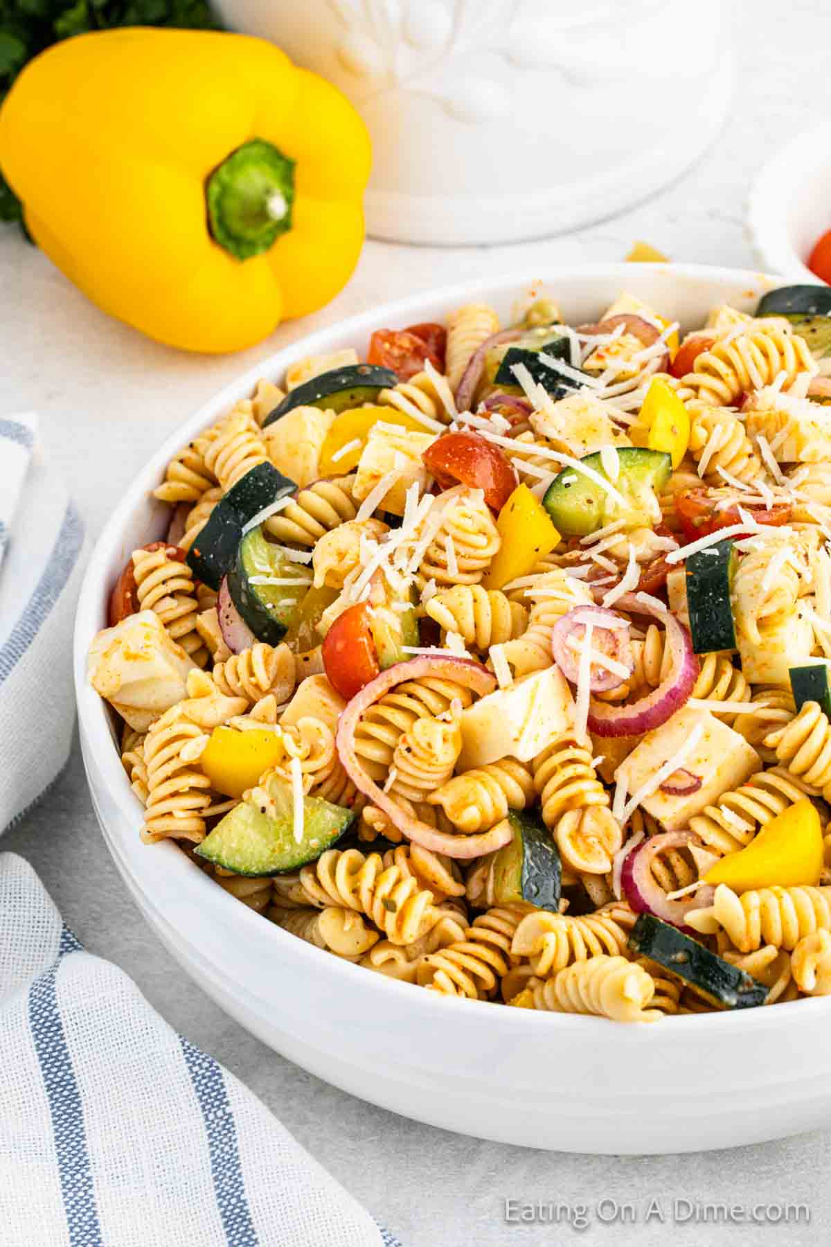 Supreme Pasta Salad in a bowl with a yellow pepper on the side