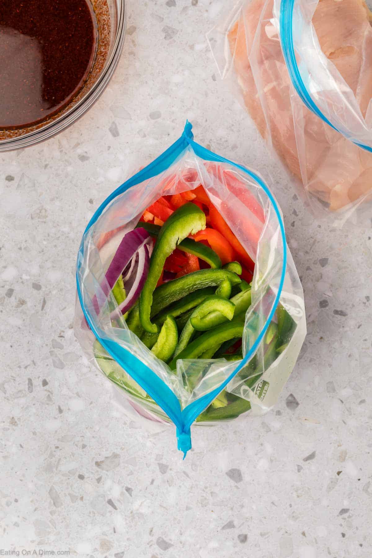 Green bell peppers and red bell peppers in a ziplock bag