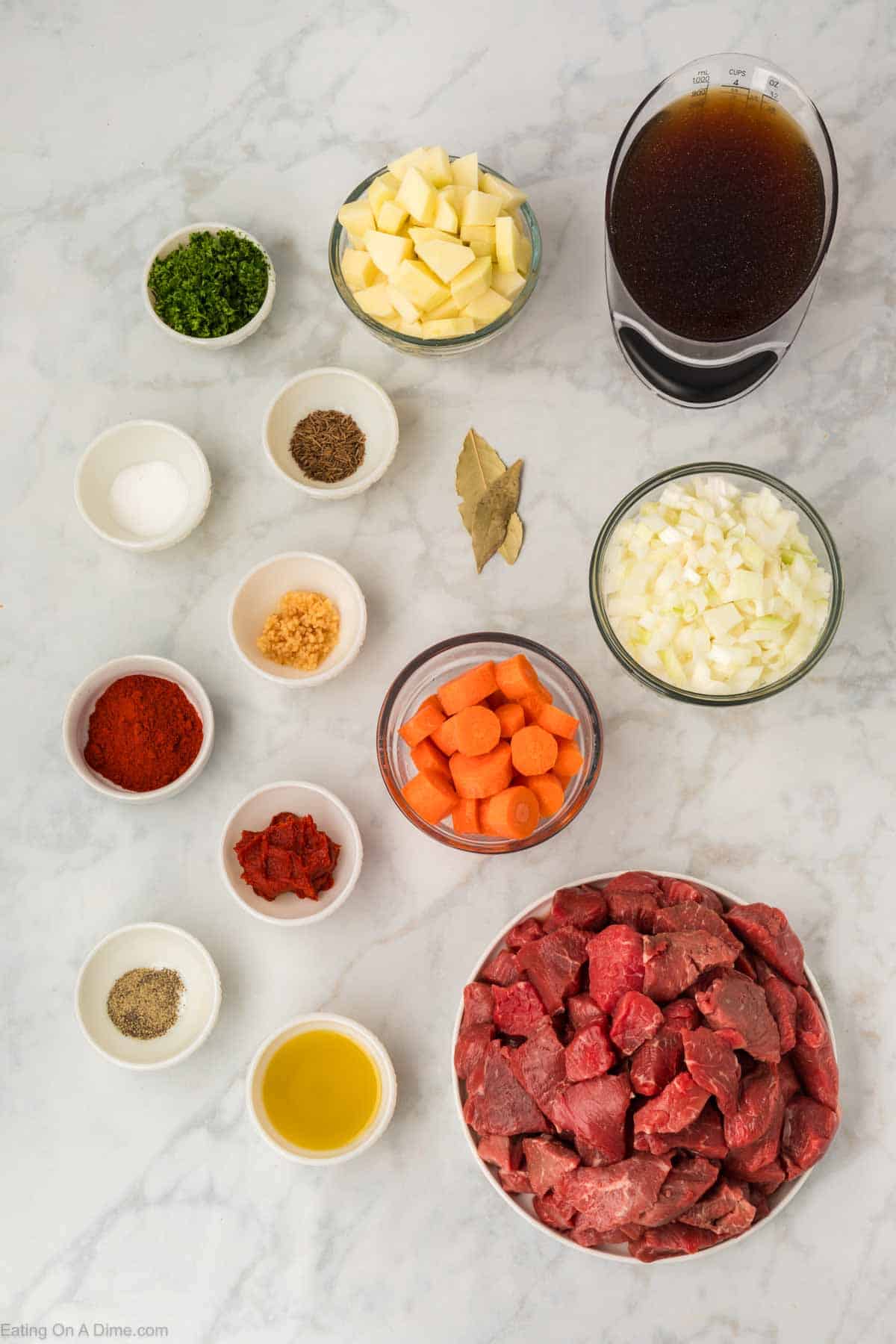 Ingredients - beef stew meat, vegetable oil, onions, garlic, sweet paprika, caraway seeds, salt, pepper, tomato paste, beef broth, carrots, potatoes, bay leaves, fresh parsley