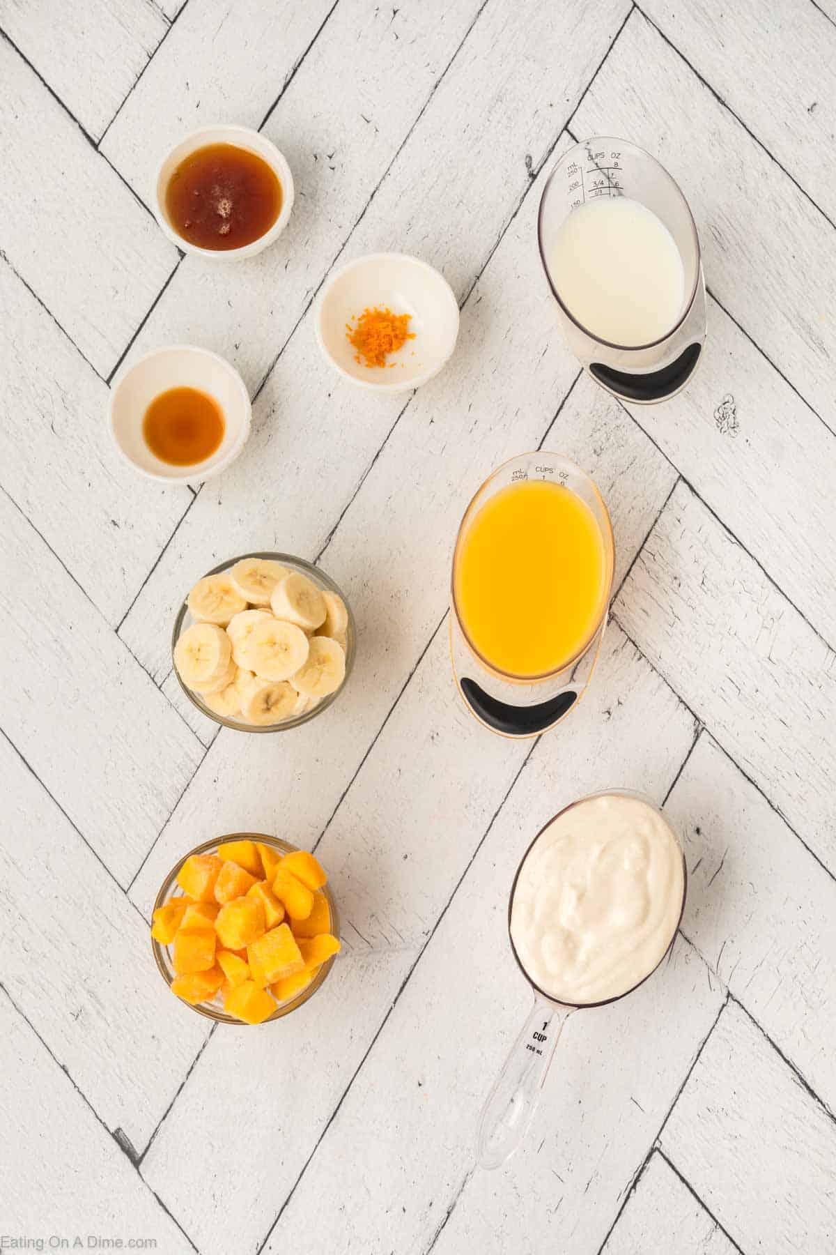 Ingredients - Vanilla Greek Yogurt, orange juice, frozen mango chunks, frozen banana slices, vanilla extract, orange zest, whole milk, honey