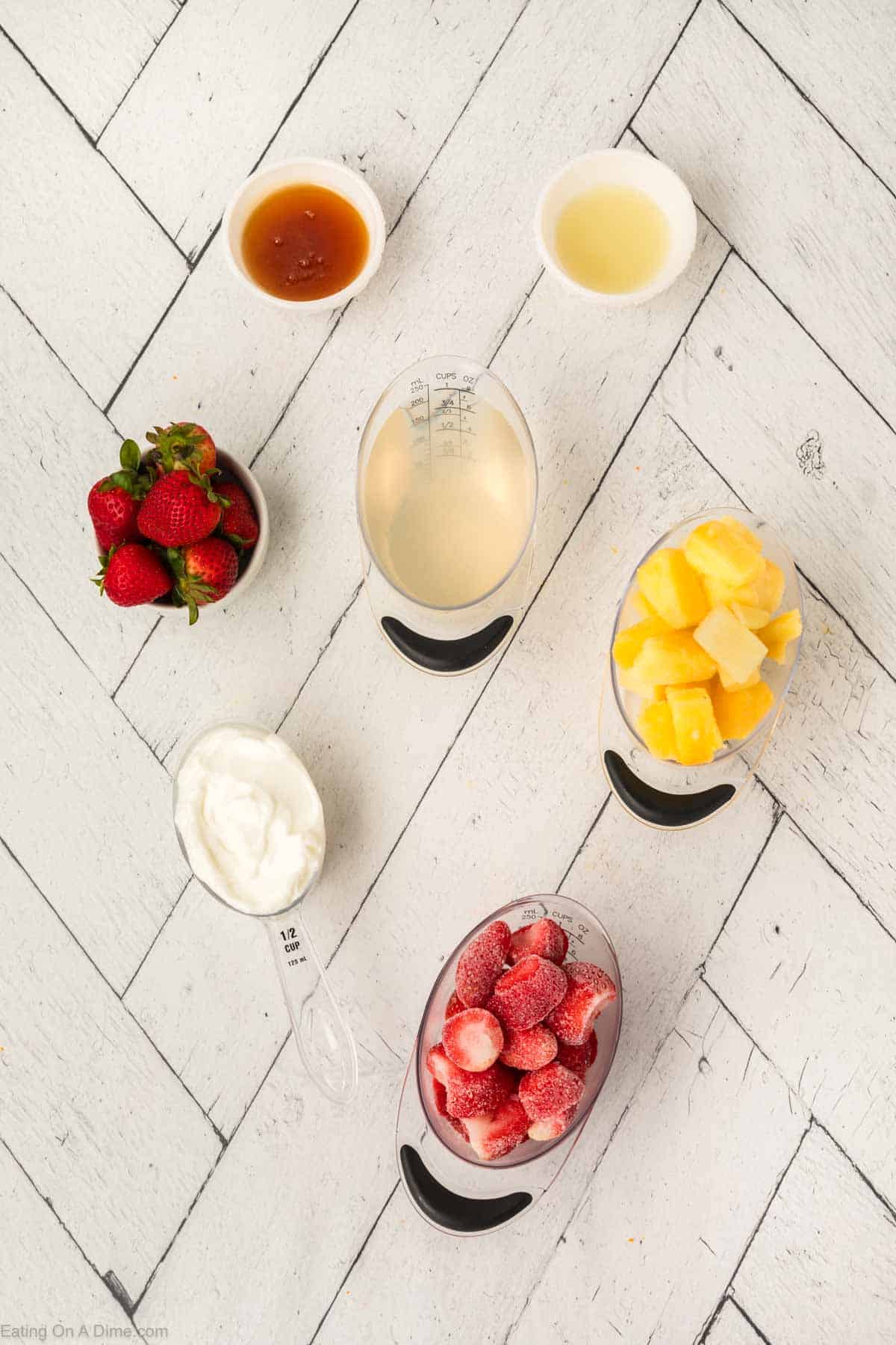 Ingredients - honey, frozen pineapple, strawberries, coconut water, yogurt, lime juice