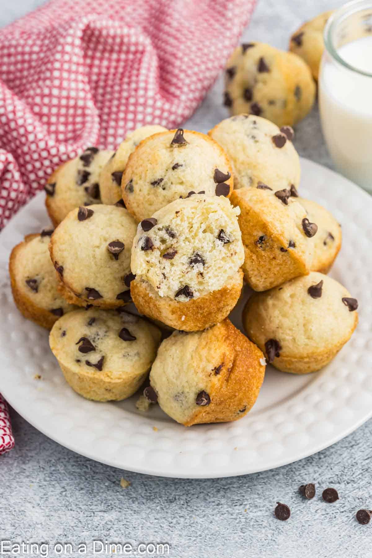 Mini chocolate chip muffins stacked on a white plate