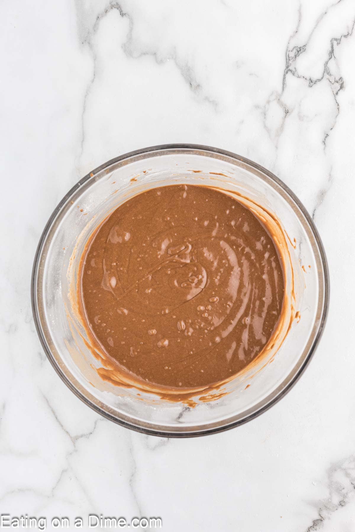 Combining the chocolate cake mix ingredients in a bowl