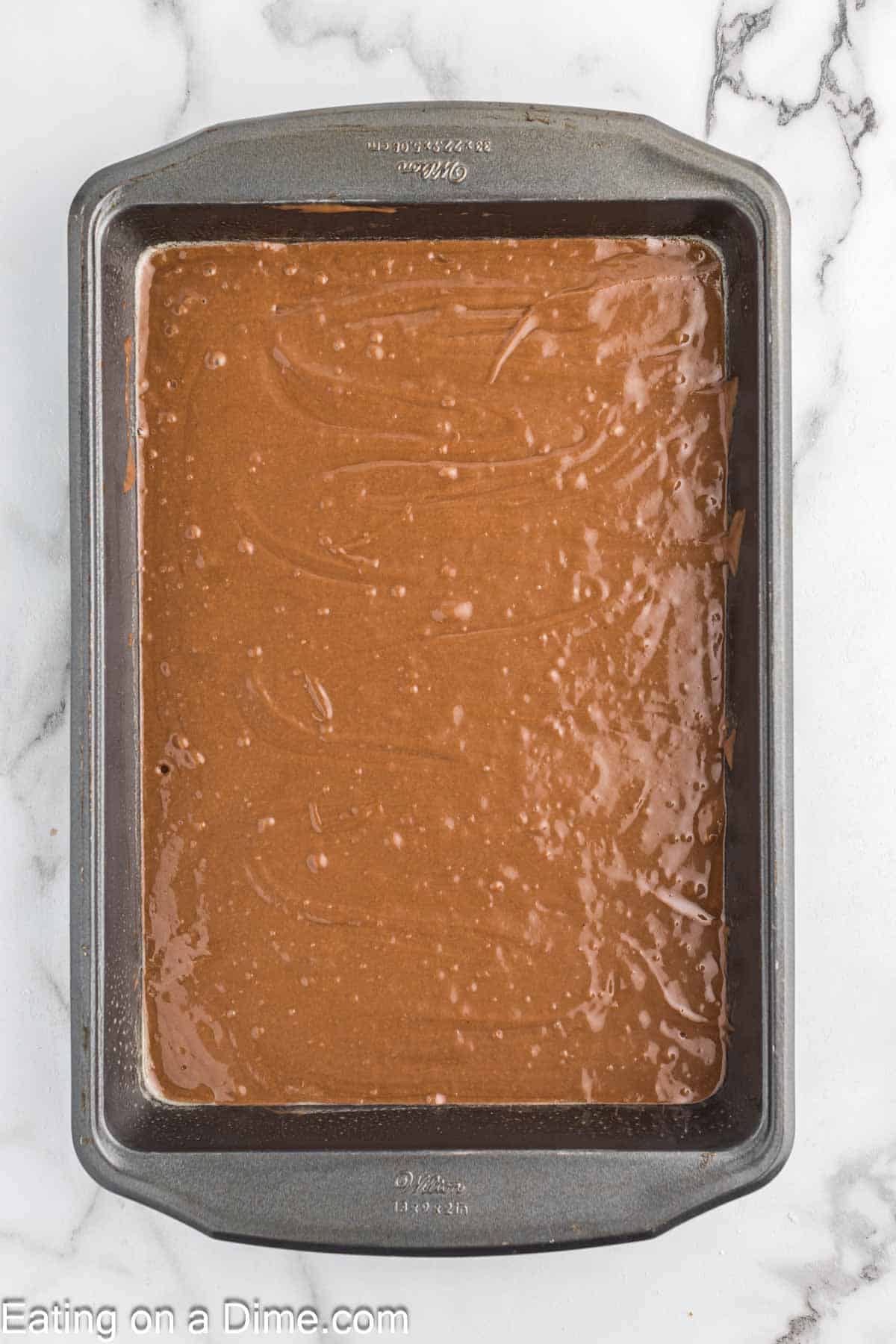 Pouring the chocolate cake batter in the baking dish