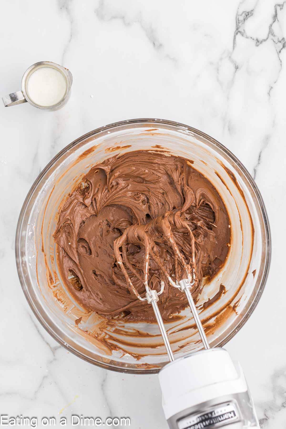 Combining the cocoa powder and heavy cream with the cream cheese mixture