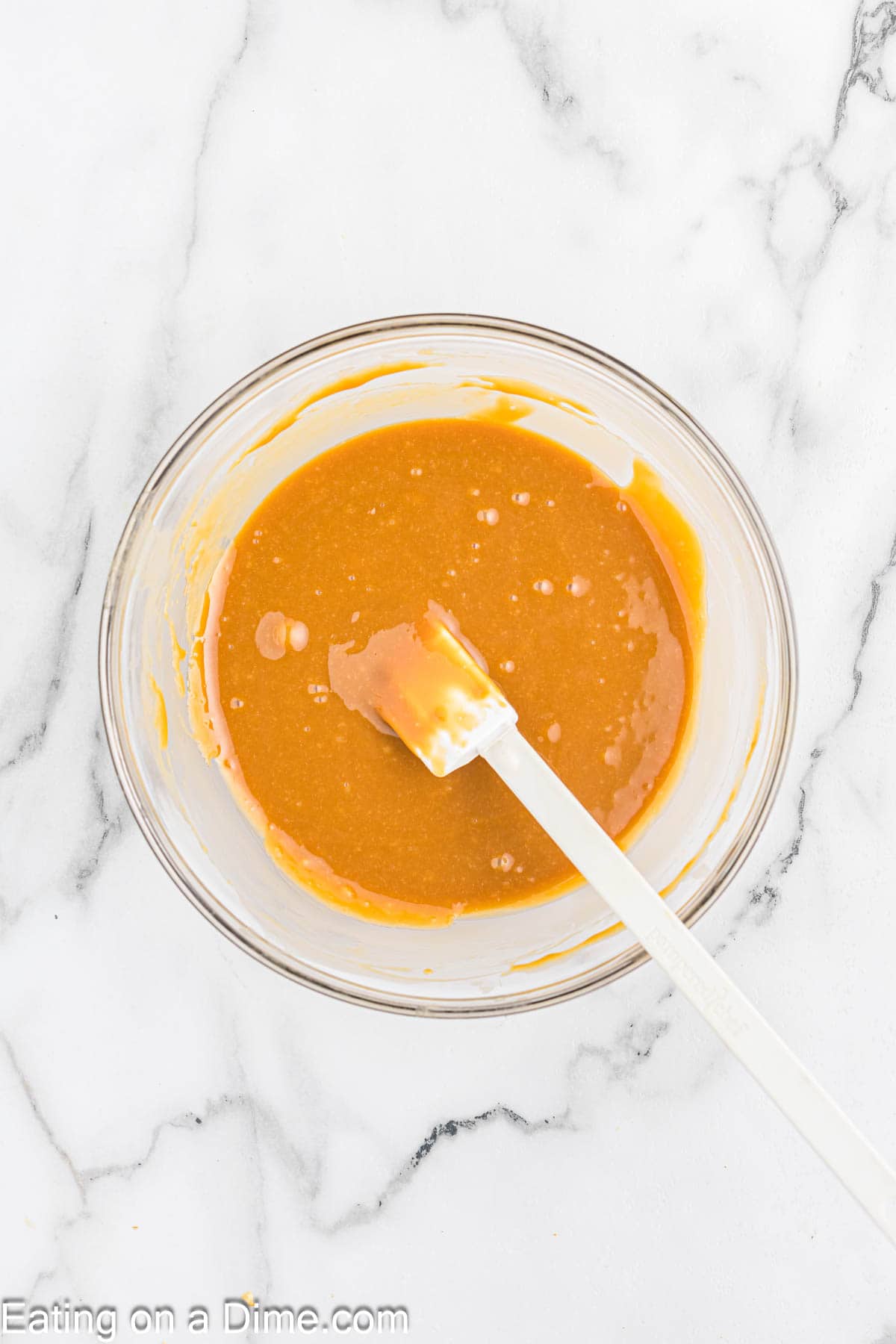 Melting caramel pieces and heavy whipping cream in a bowl