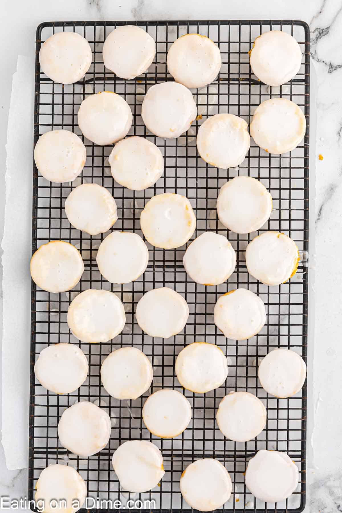 Dipped lemon blossoms on a wire rack