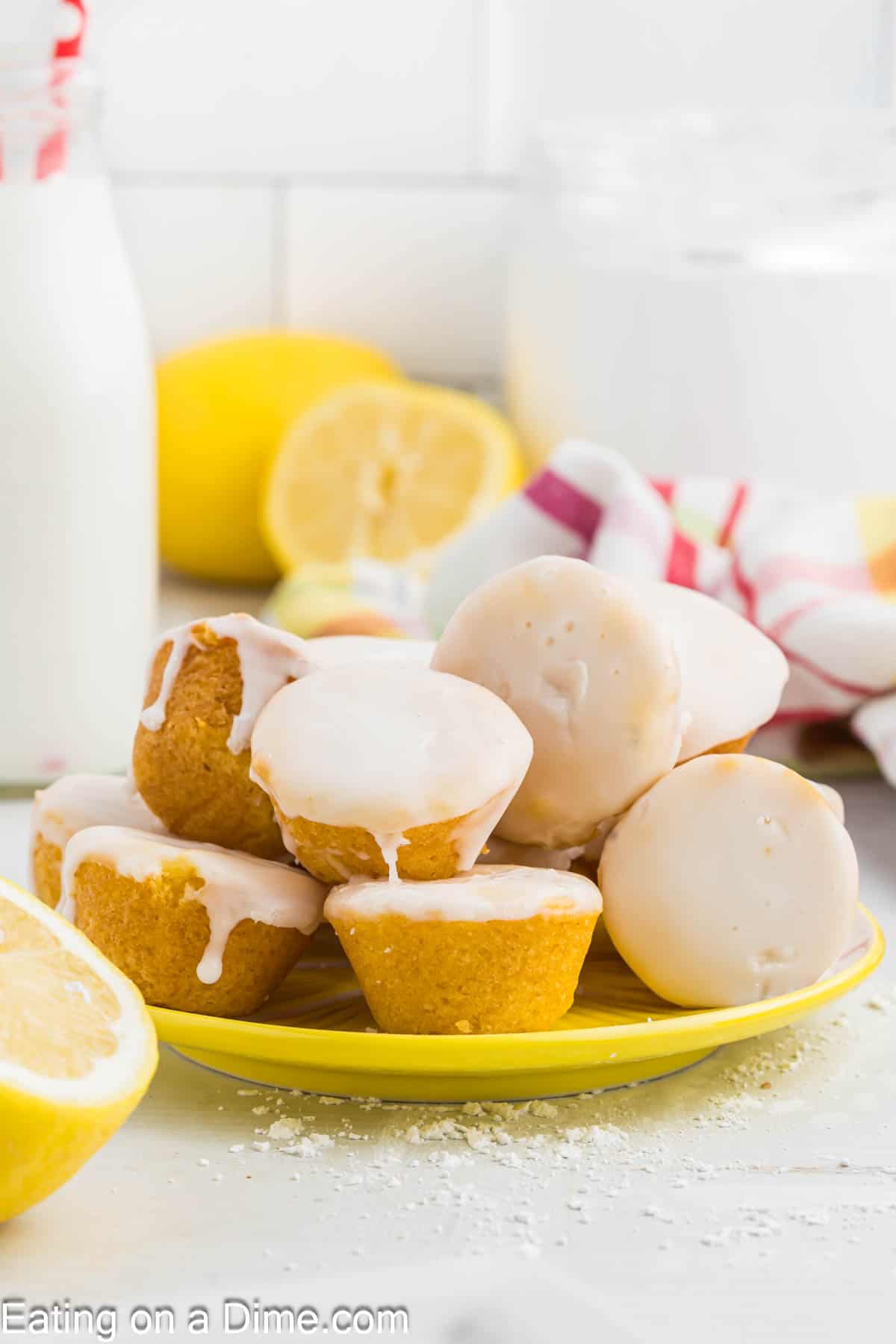 Lemon Blossoms topped with glaze and stacked on a yellow platter