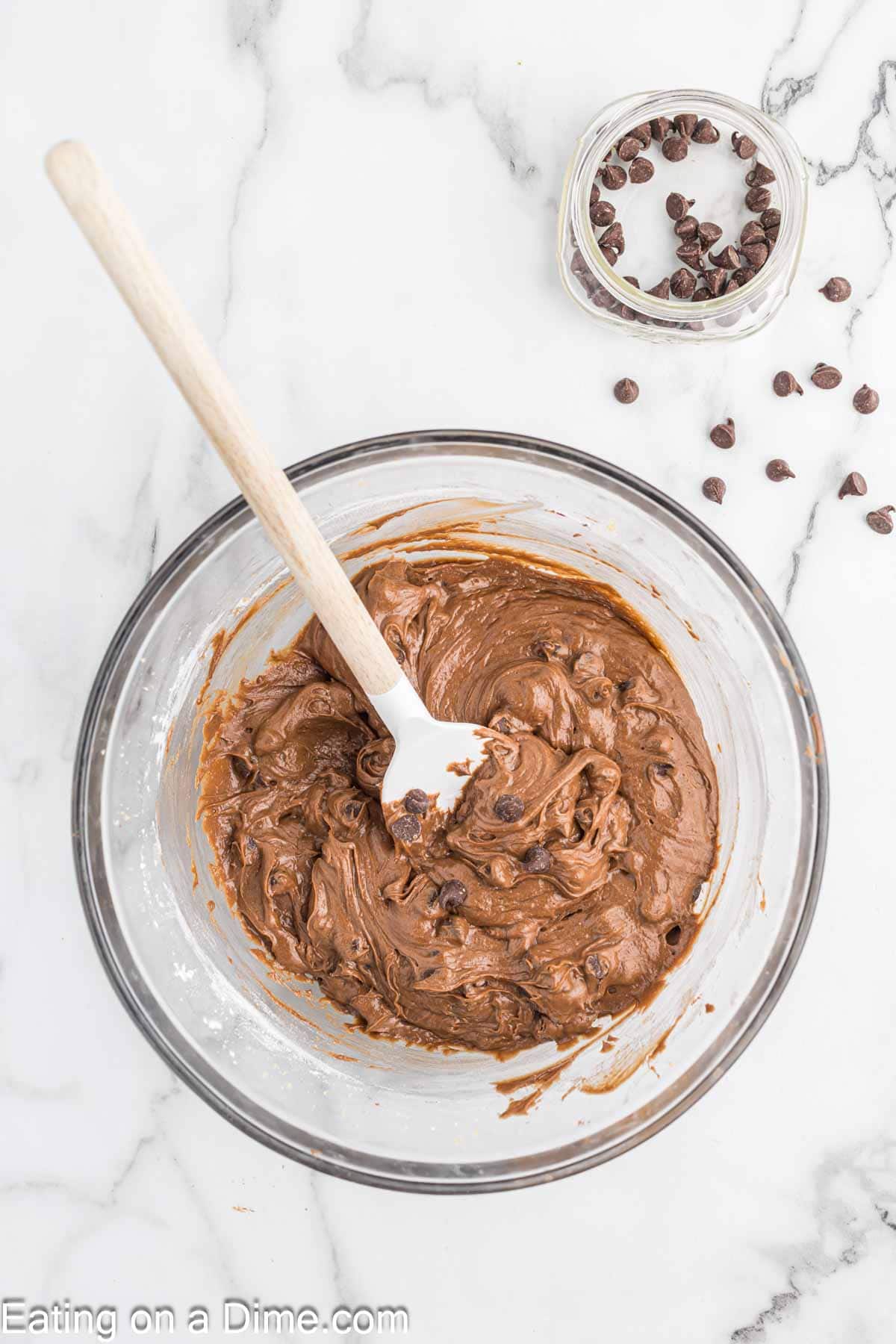 Nutella Brownie Batter mixing with chocolate chips in a bowl with spatula