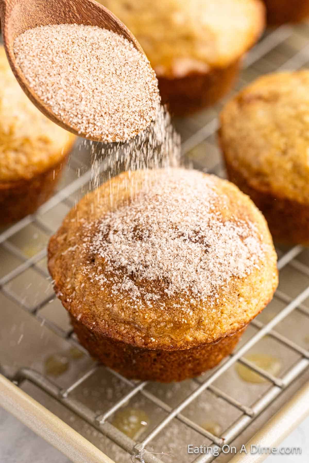 Sprinkle cinnamon sugar mixture over the muffins on a wire rack